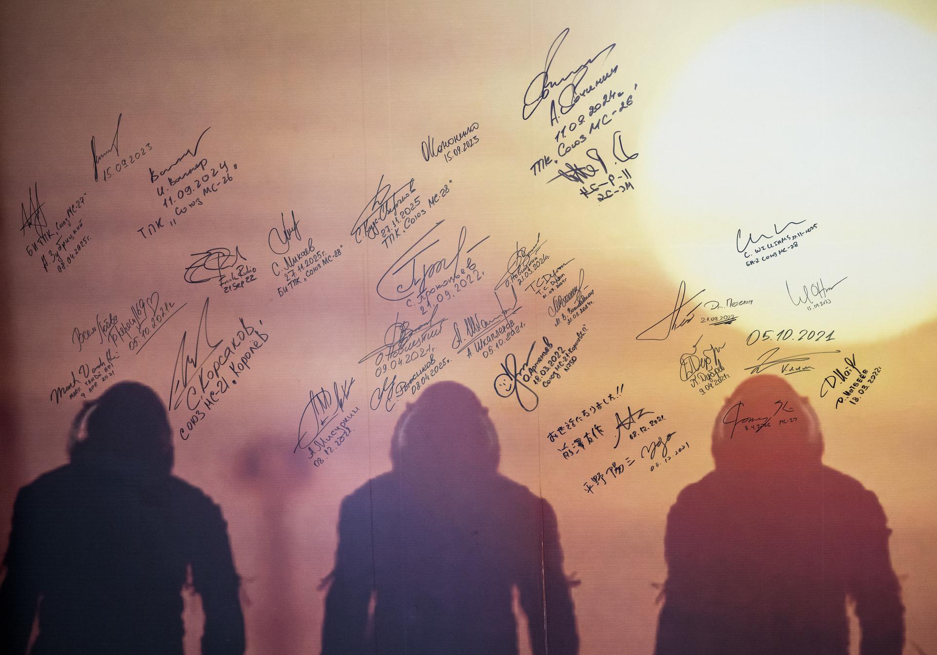 A mural with astronaut, and cosmonaut, signatures is seen, Tuesday, July 14, 2026, at the Cosmonaut Hotel in Baikonur, Kazakhstan. Expedition 75 NASA astronaut Anil Menon, Roscosmos cosmonauts Anna Kikina, and Pyotr Dubrov, will sign the mural as they depart for suit up and  launch for a mission to the International Space Station. Photo Credit: (NASA/Bill Ingalls)