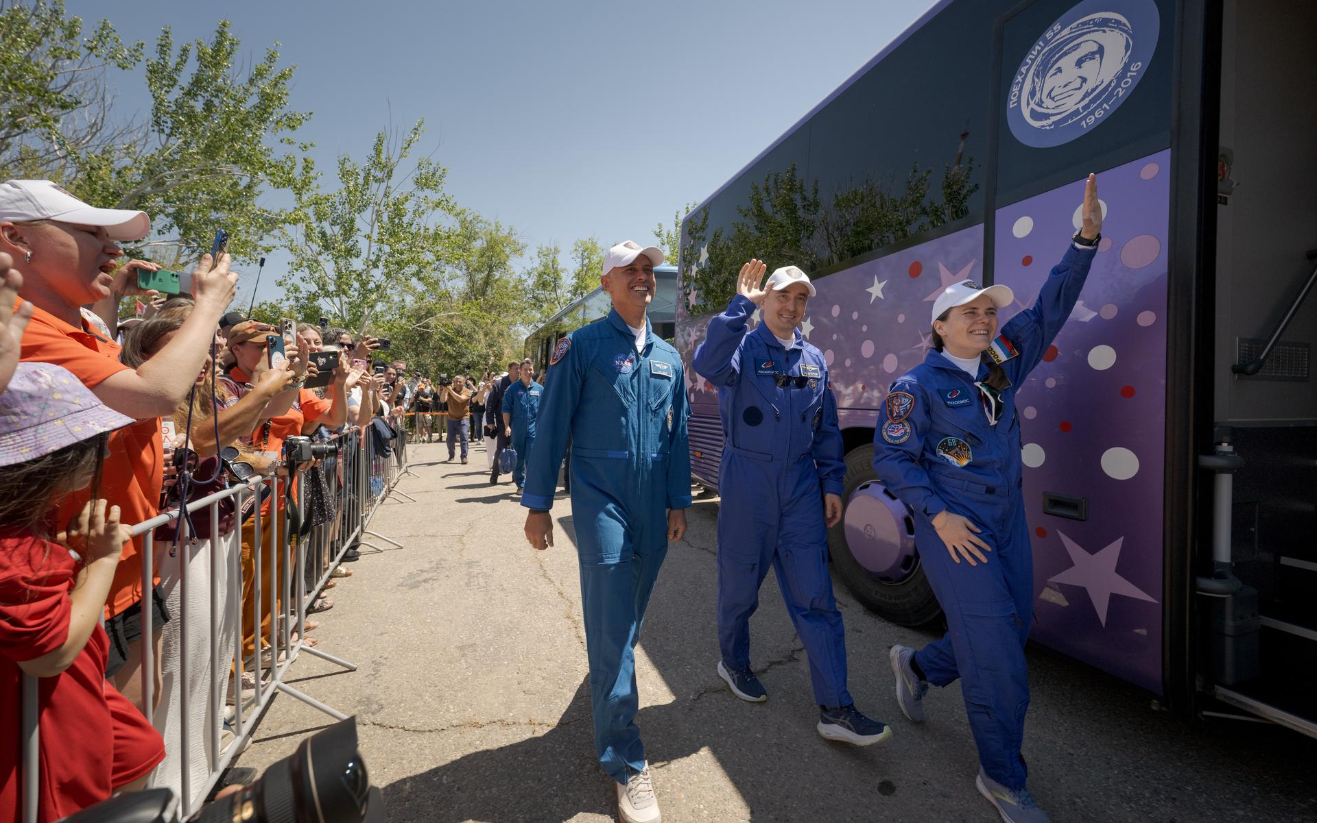 Expedition 75 crew members: NASA astronaut Anil Menon, left, Roscosmos cosmonauts Pyotr Dubrov, and Anna Kikina, right, depart the Cosmonaut Hotel to suit-up for their Soyuz launch, Tuesday, July 14, 2026, in Baikonur, Kazakhstan. The launch will send Menon, Dubrov, and Kikina on a mission to the International Space Station. Photo Credit: (NASA/Bill Ingalls)