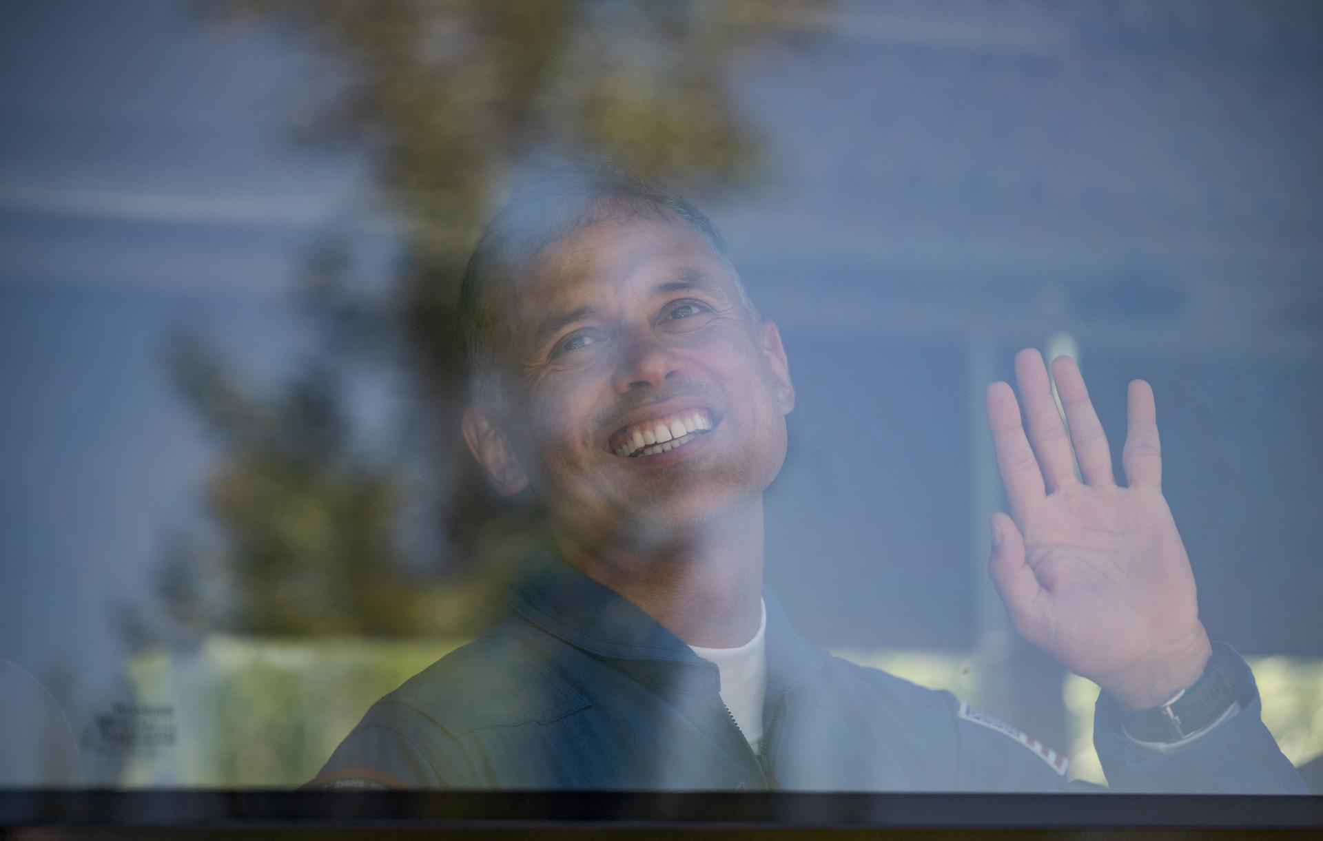 Expedition 75 NASA astronaut Anil Menon waves as he and fellow crew mates, Roscosmos cosmonauts Pyotr Dubrov, and Anna Kikina depart the Cosmonaut Hotel to suit-up for their Soyuz launch, Tuesday, July 14, 2026, in Baikonur, Kazakhstan. The launch will send Menon, Dubrov, and Kikina on a mission to the International Space Station. Photo Credit: (NASA/Bill Ingalls)