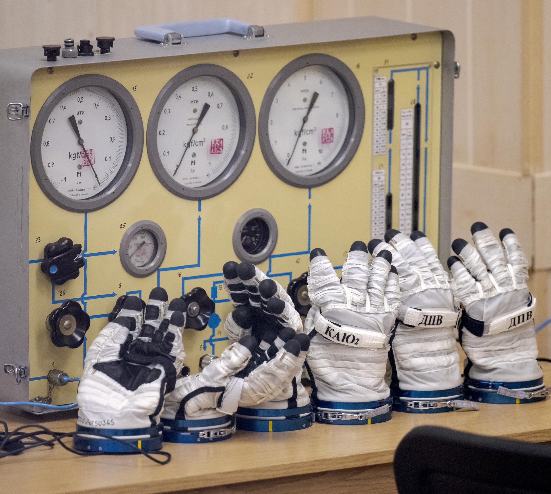Russian Sokol Suit gloves are seen inside building 254 of the Baikonur Cosmodrome where Expedition 75 crew members: NASA astronaut Anil Menon, Roscosmos cosmonauts Pyotr Dubrov, and Anna Kikina, will suit up ahead of their Soyuz launch to the International Space Station Tuesday, July 14, 2026 in Baikonur, Kazakhstan. The launch will send Menon, Dubrov, and Kikina on a mission to the International Space Station. Photo Credit: (NASA/Bill Ingalls)