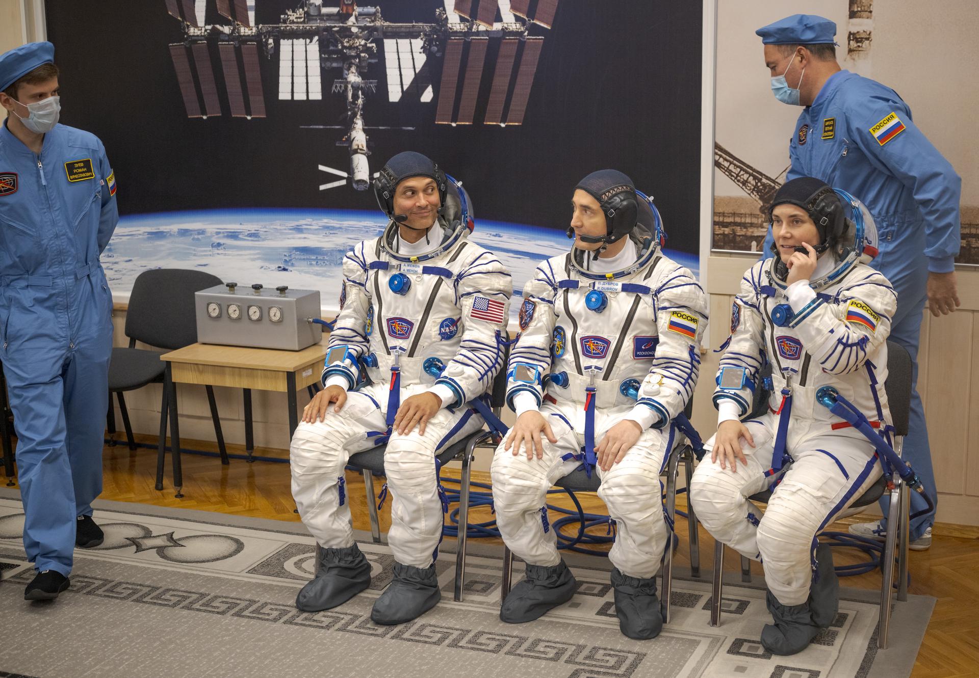 Expedition 75 crew members: NASA astronaut Anil Menon, left, Roscosmos cosmonauts Pyotr Dubrov, and Anna Kikina, right, prepare to have their Russian Sokol suits pressure checked as they ready for their Soyuz launch to the International Space Station Tuesday, July 14, 2026 in Baikonur, Kazakhstan. Photo Credit: (NASA/Bill Ingalls)