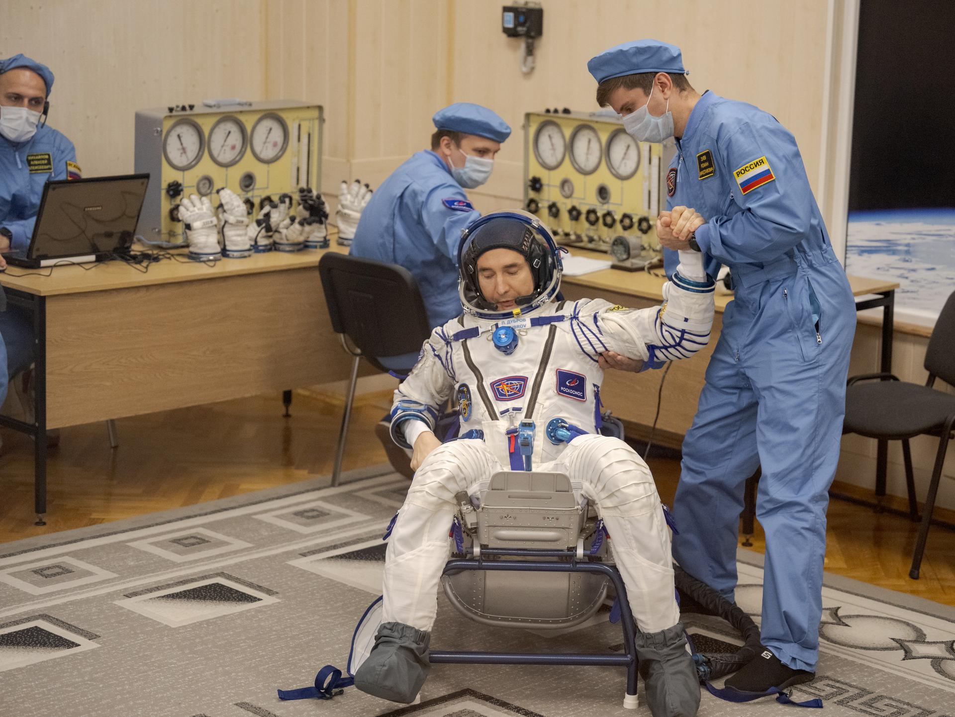 Expedition 75 Roscosmos cosmonaut Pyotr Dubrov has his Russian Sokol suit pressure checked as he and fellow crewmates, Roscosmos cosmonaut Anna Kikina, and NASA astronaut Anil Menon, prepare for their Soyuz launch to the International Space Station Tuesday, July 14, 2026 in Baikonur, Kazakhstan. Photo Credit: (NASA/Bill Ingalls)