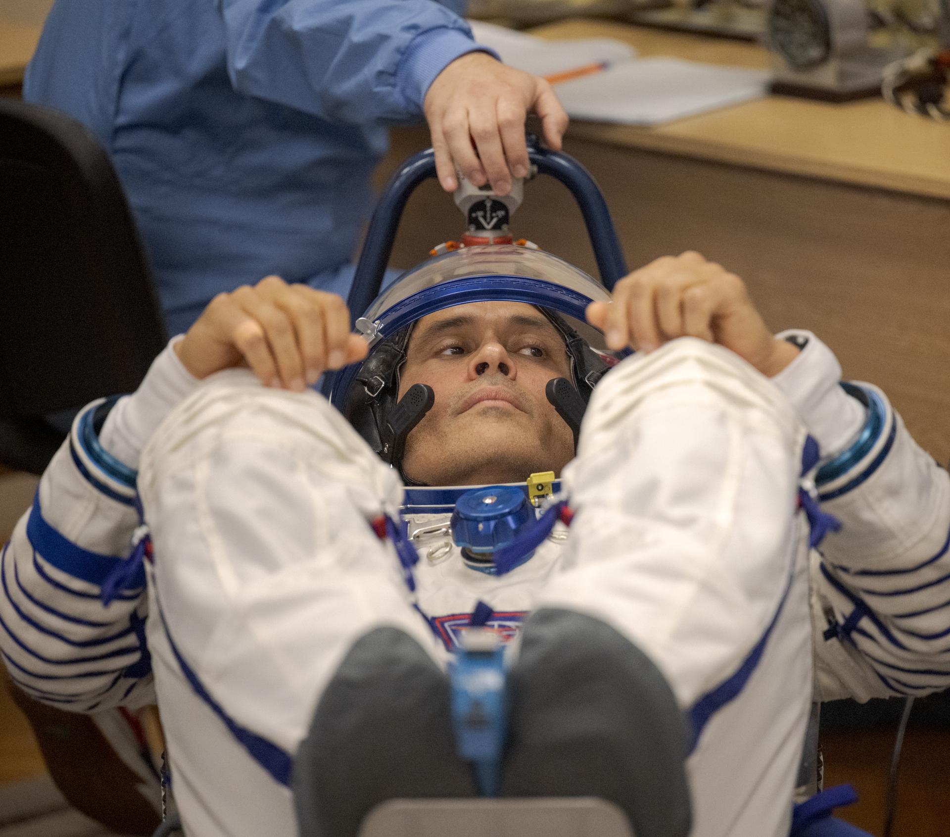Expedition 75 NASA astronaut Anil Menon has his Russian Sokol suit pressure checked as he and fellow crewmates, Roscosmos cosmonauts Anna Kikina, and Pyotr Dubrov, prepare for their Soyuz launch to the International Space Station Tuesday, July 14, 2026 in Baikonur, Kazakhstan. Photo Credit: (NASA/Bill Ingalls)