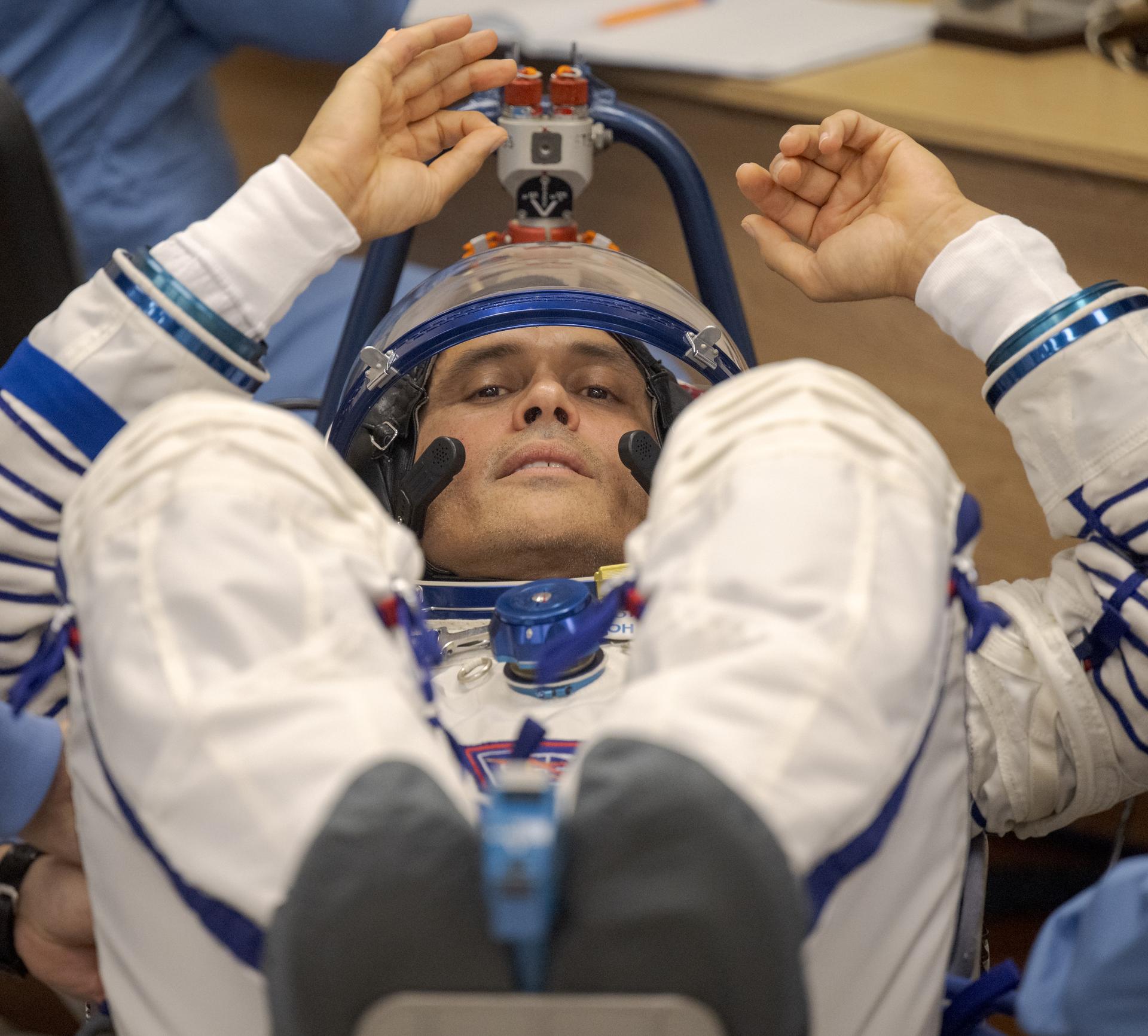 Expedition 75 NASA astronaut Anil Menon has his Russian Sokol suit pressure checked as he and fellow crewmates, Roscosmos cosmonauts Anna Kikina, and Pyotr Dubrov, prepare for their Soyuz launch to the International Space Station Tuesday, July 14, 2026 in Baikonur, Kazakhstan. Photo Credit: (NASA/Bill Ingalls)