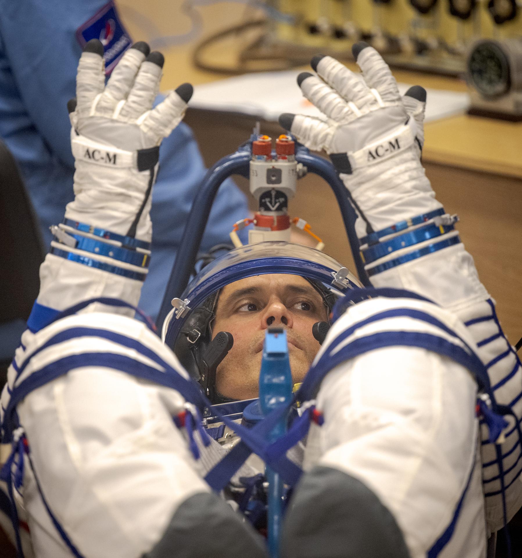 Expedition 75 NASA astronaut Anil Menon has his Russian Sokol suit pressure checked as he and fellow crewmates, Roscosmos cosmonauts Anna Kikina, and Pyotr Dubrov, prepare for their Soyuz launch to the International Space Station Tuesday, July 14, 2026 in Baikonur, Kazakhstan. Photo Credit: (NASA/Bill Ingalls)