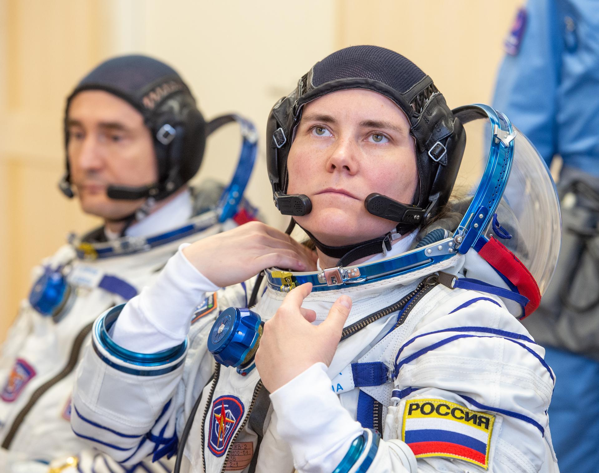 Expedition 75 Roscosmos cosmonaut Anna Kikina is helped into her Russian Sokol suit as she and fellow crew mates, Roscosmos cosmonaut Pyotr Dubrov, and NASA astronaut Anil Menon, prepare for their Soyuz launch to the International Space Station Tuesday, July 14, 2026 in Baikonur, Kazakhstan. The launch will send Menon, Dubrov, and Kikina on a mission to the International Space Station. Photo Credit: (NASA/GCTC/Pavel Shvets)