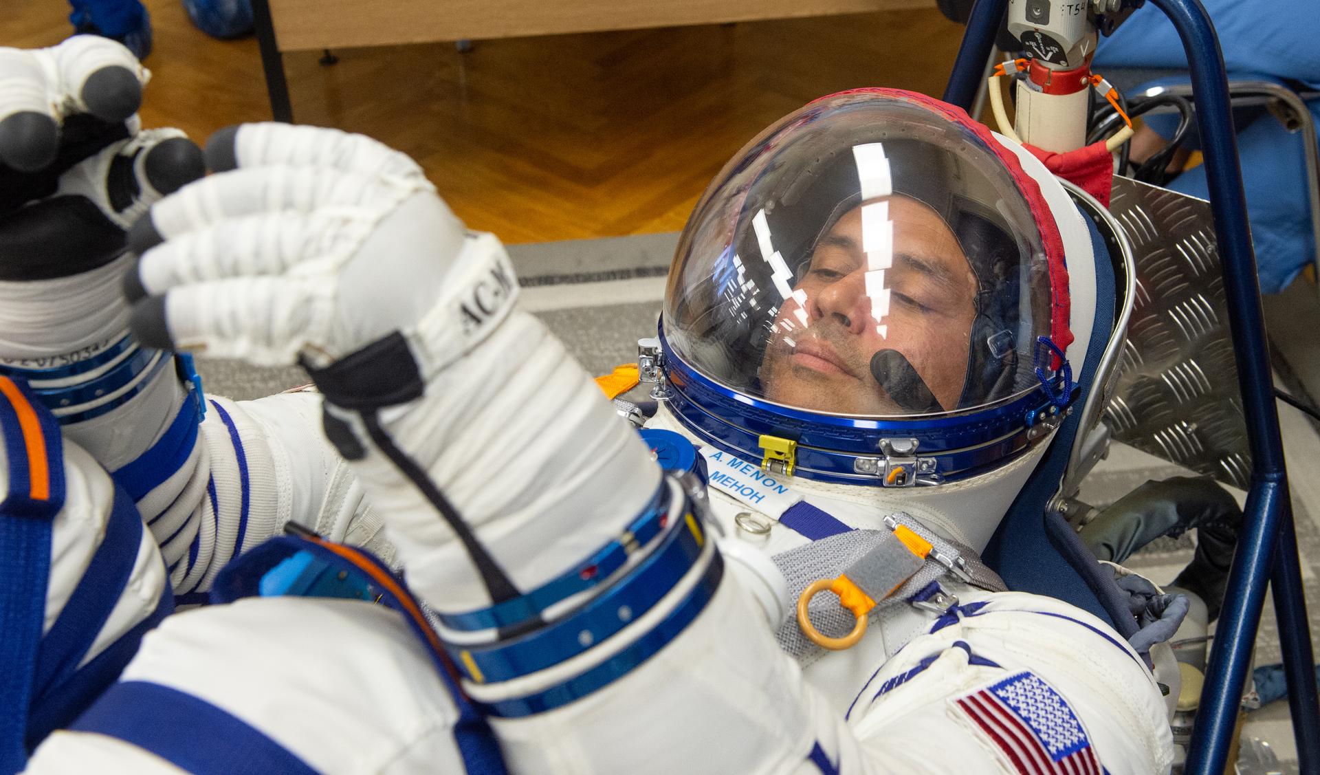 Expedition 75 NASA astronaut Anil Menon has his Russian Sokol suit pressure checked as he and fellow crew mates, Roscosmos cosmonauts Anna Kikina, and Pyotr Dubrov, prepare for their Soyuz launch to the International Space Station Tuesday, July 14, 2026 in Baikonur, Kazakhstan. Photo Credit: (NASA/GCTC/Pavel Shvets)