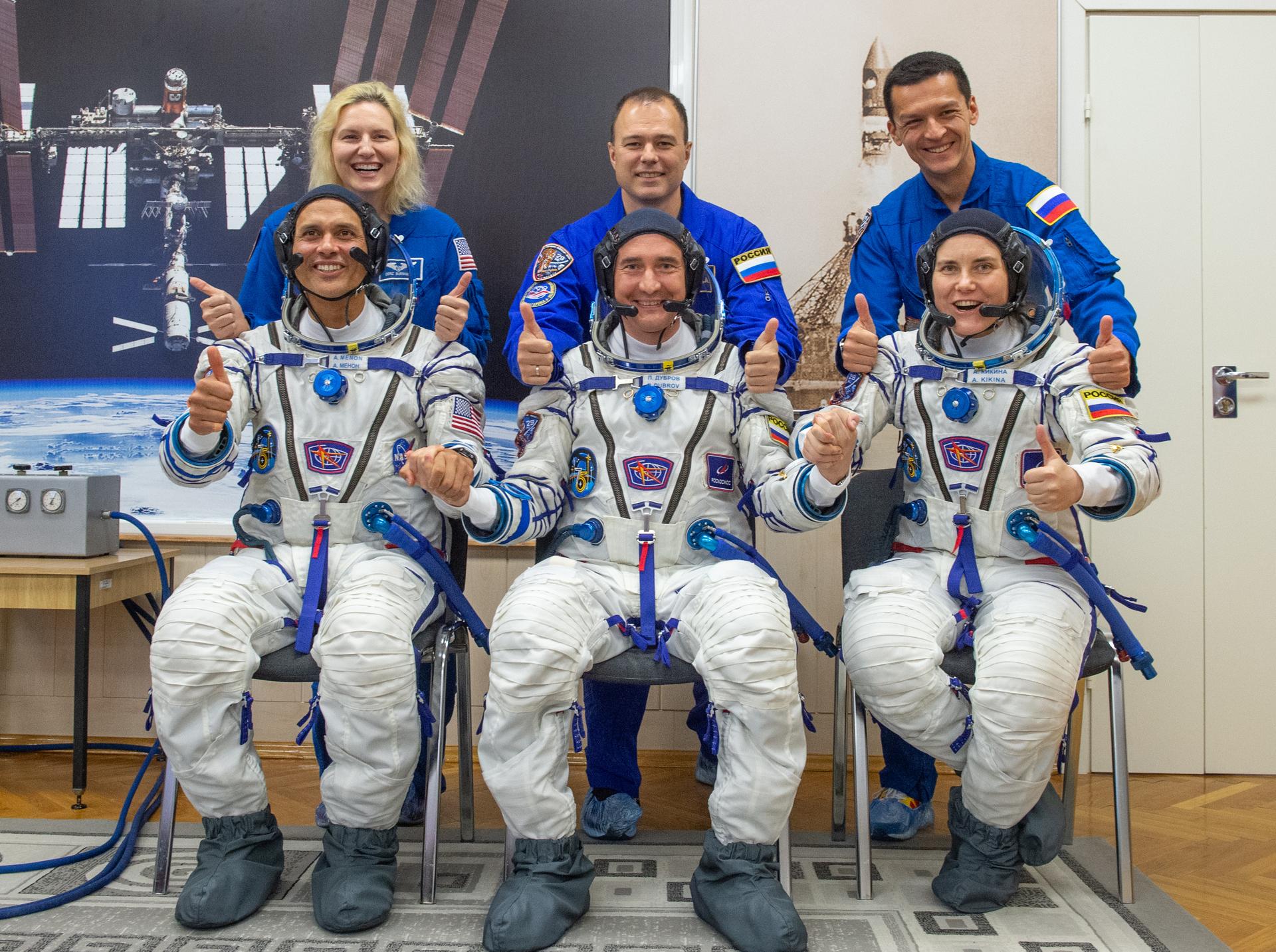 Expedition 75 prime crewmembers: NASA astronaut Anil Menon, seated left, Roscosmos cosmonauts Pyotr Dubrov, and Anna Kikina, seated right, joined by backup crew members, Deniz Burnham of NASA, standing left, Roscosmos cosmonauts Dmitry Petelin, and Konstantin Borisov, standing right, pose for a group photograph as the prime crew prepares for their Soyuz launch to the International Space Station Tuesday, July 14, 2026 in Baikonur, Kazakhstan. Photo Credit: (NASA/GCTC/Pavel Shvets)