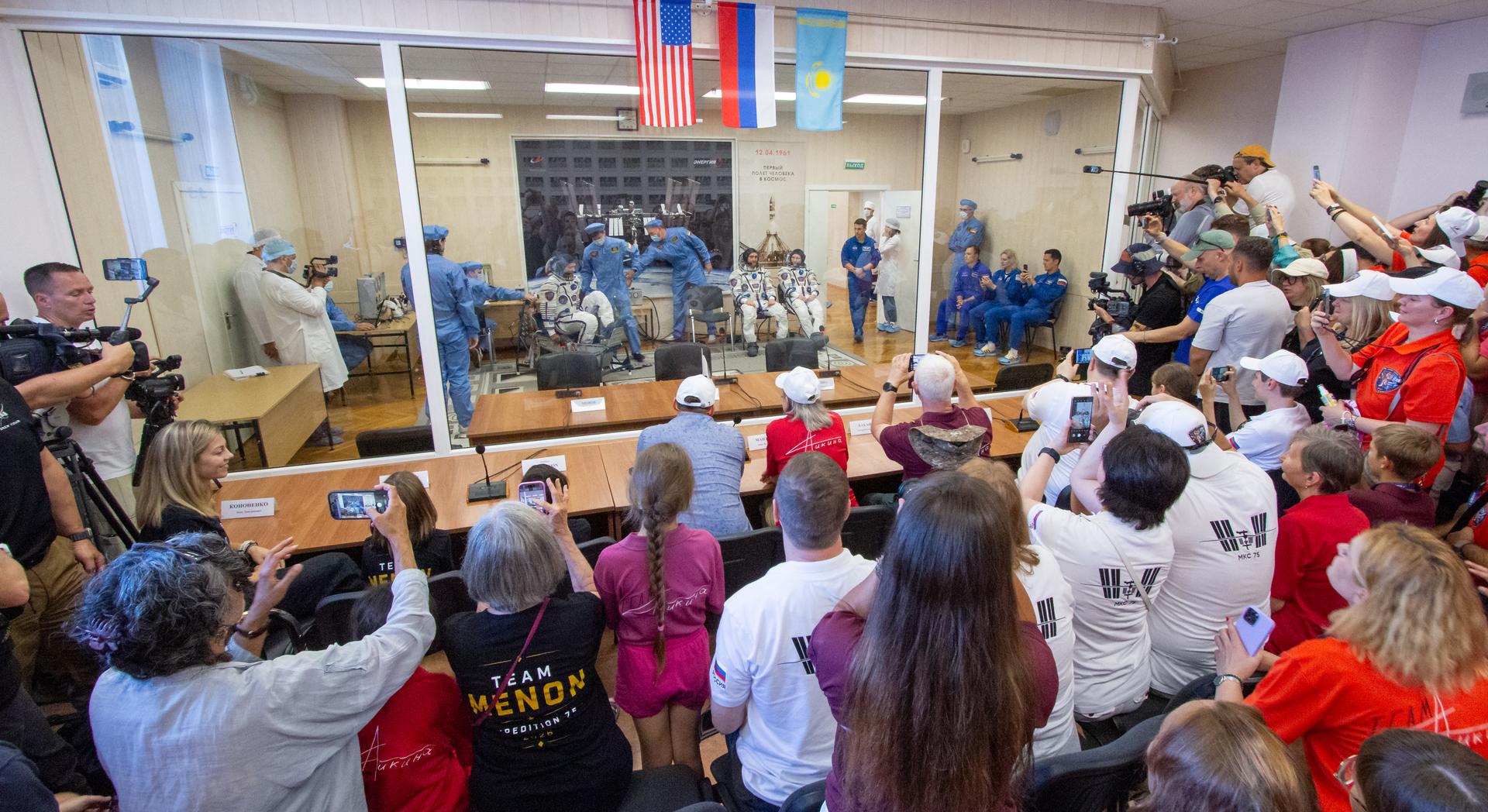 Expedition 75 crewmemebers: NASA astronaut Anil Menon, left, Roscosmos cosmonauts Pyotr Dubrov, and Anna Kikina, right, have their Russian Sokol Suits pressure checked as they prepare for their Soyuz launch to the International Space Station Tuesday, July 14, 2026 in Baikonur, Kazakhstan. Photo Credit: (NASA/Victor Zelentsov)