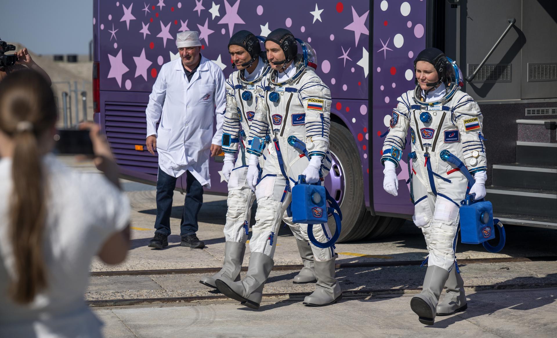 Expedition 75 crewmembers: NASA astronaut Anil Menon, left, Roscosmos cosmonauts Pyotr Dubrov, and Anna Kikina, right, arrive at the launch pad to board the Soyuz MS-29 spacecraft for launch, Tuesday, July 14, 2026 at the Baikonur Cosmodrome in Kazakhstan. Launch of the Soyuz rocket will send the trio on a mission to the International Space Station. Photo Credit: (NASA/Bill Ingalls)