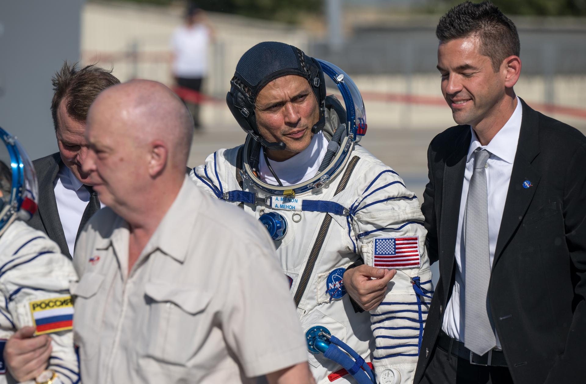 Expedition 75 NASA astronaut Anil Menon walks with NASA Deputy Administrator Matt Anderson, left, and NASA Administrator Jared Isaacman, right, to board the Soyuz MS-29 spacecraft for launch with Roscosmos cosmonauts Anna Kikina, and Pyotr Dubrov, Tuesday, July 14, 2026 at the Baikonur Cosmodrome in Kazakhstan. Launch of the Soyuz rocket will send the trio on a mission to the International Space Station. Photo Credit: (NASA/Bill Ingalls)