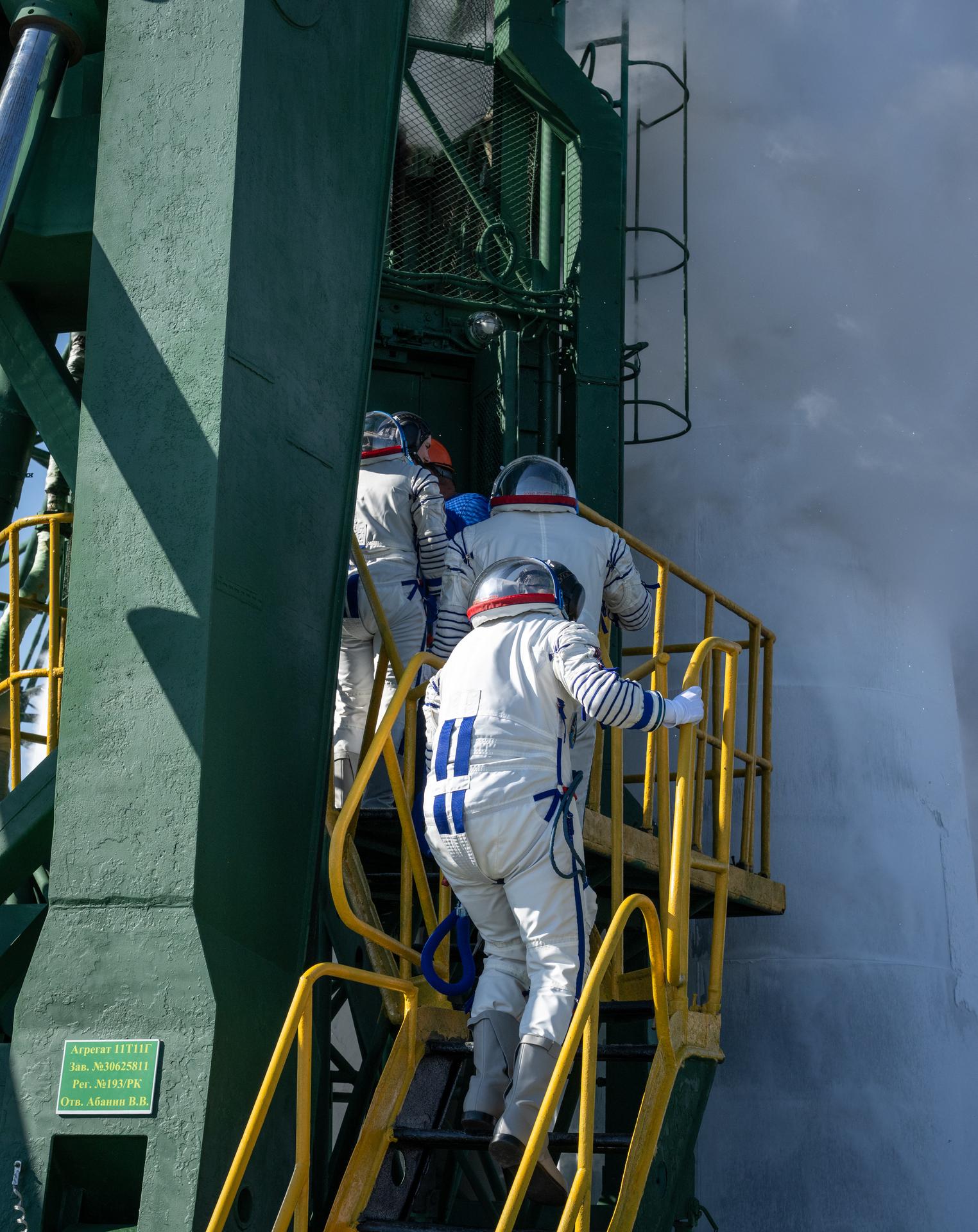 Expedition 75 crewmembers: NASA astronaut Anil Menon, Roscosmos cosmoanuts Pyotr Dubrov, and Anna Kikina, get in an elevator to board the Soyuz MS-29 spacecraft for launch, Tuesday, July 14, 2026 at the Baikonur Cosmodrome in Kazakhstan. Launch of the Soyuz rocket will send the trio on a mission to the International Space Station. Photo Credit: (NASA/Bill Ingalls)
