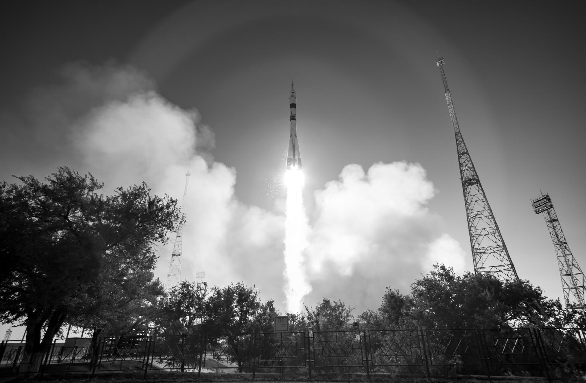 In this black and white infrared image, the Soyuz rocket launches to the International Space Station with Expedition 75 crewmembers: NASA astronaut Anil Menon, Roscosmos cosmonauts Pyotr Dubrov, and Anna Kikina onboard, Tuesday, July 14, 2026, at the Baikonur Cosmodrome in Kazakhstan. Photo Credit: (NASA/Bill Ingalls)