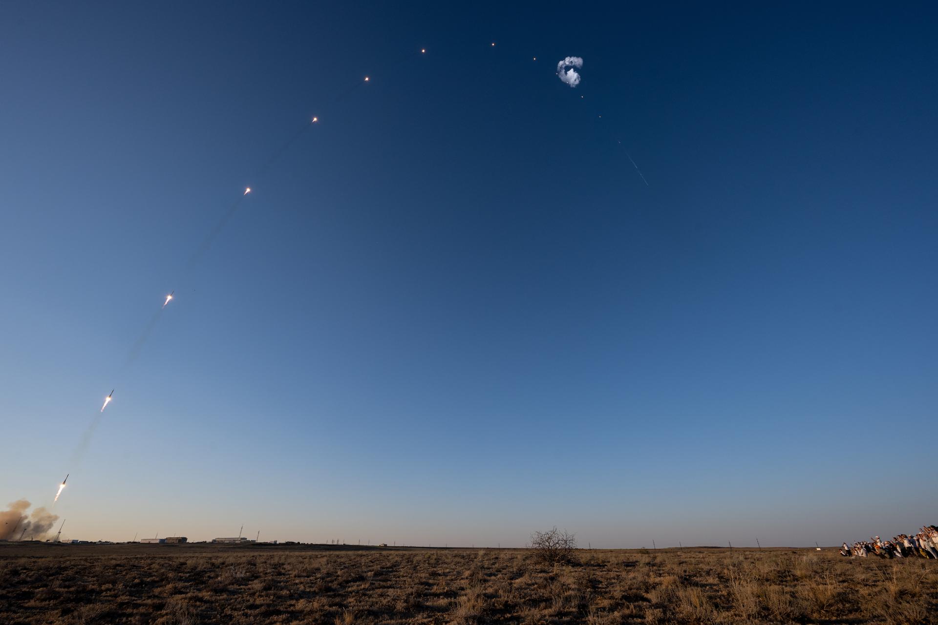 This composite image made from 18 frames shows the Soyuz rocket as it launches to the International Space Station with Expedition 75 crewmembers: NASA astronaut Anil Menon, Roscosmos cosmonauts Pyotr Dubrov, and Anna Kikina onboard, Tuesday, July 14, 2026, at the Baikonur Cosmodrome in Kazakhstan. Photo Credit: (NASA/Bill Ingalls)