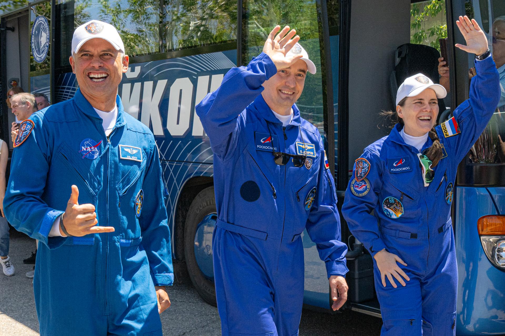 Expedition 75 crewmembers NASA astronaut Anil Menon, left, and Roscosmos cosmonauts Pyotr Dubrov and Anna Kikina, right, depart the Cosmonaut Hotel to suit up for launch, Tuesday, July 14, 2026, in Baikonur, Kazakhstan. The launch will send the trio to the International Space Station aboard the Soyuz MS-29 spacecraft. Photo Credit: (NASA/John Kraus)