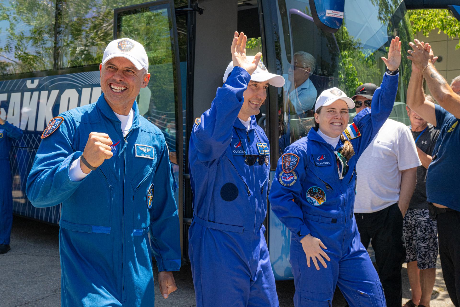 Expedition 75 crewmembers NASA astronaut Anil Menon, left, and Roscosmos cosmonauts Pyotr Dubrov and Anna Kikina, right, depart the Cosmonaut Hotel to suit up for launch, Tuesday, July 14, 2026, in Baikonur, Kazakhstan. The launch will send the trio to the International Space Station aboard the Soyuz MS-29 spacecraft. Photo Credit: (NASA/John Kraus)