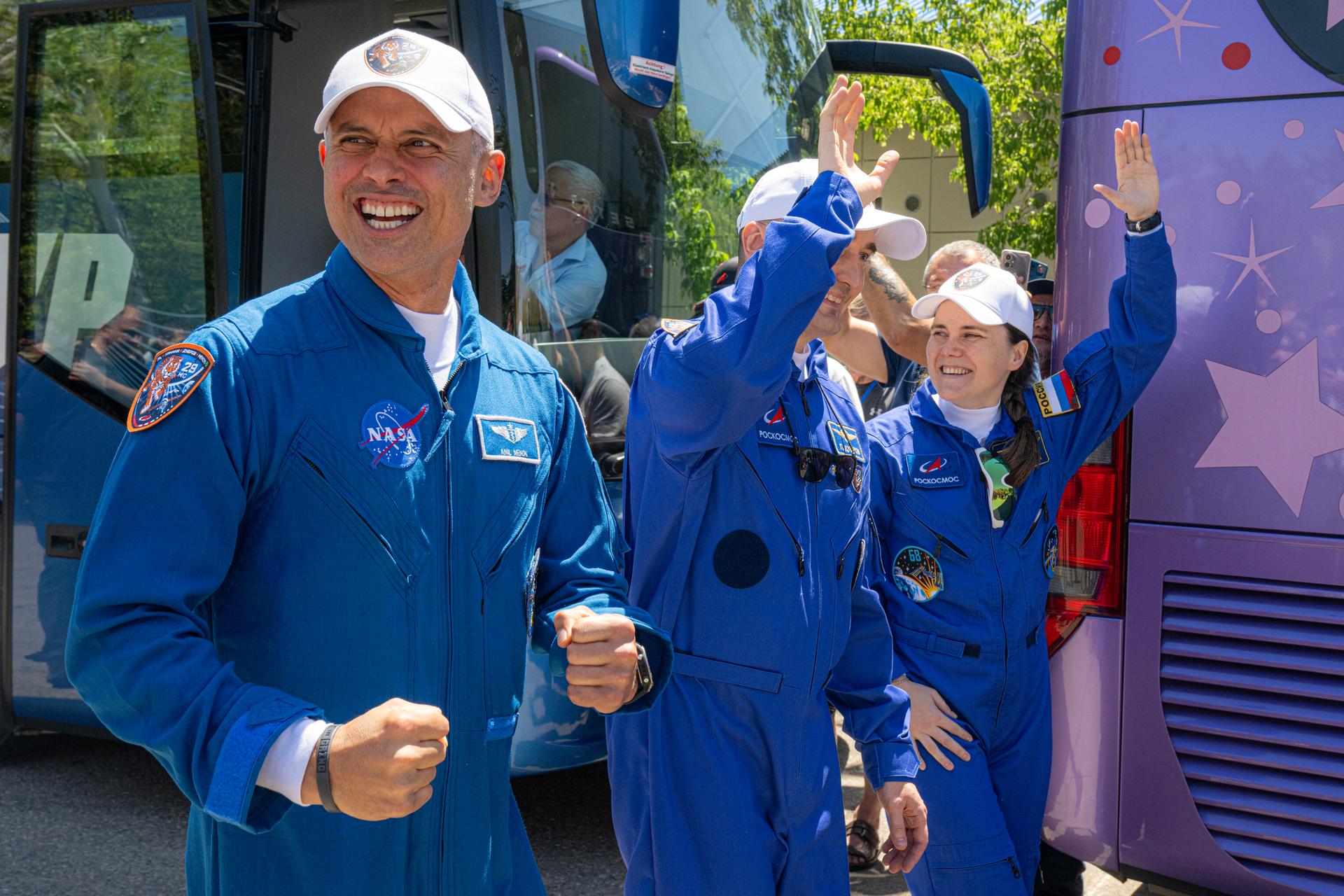 Expedition 75 crewmembers NASA astronaut Anil Menon, left, and Roscosmos cosmonauts Pyotr Dubrov and Anna Kikina, right, depart the Cosmonaut Hotel to suit up for launch, Tuesday, July 14, 2026, in Baikonur, Kazakhstan. The launch will send the trio to the International Space Station aboard the Soyuz MS-29 spacecraft. Photo Credit: (NASA/John Kraus)