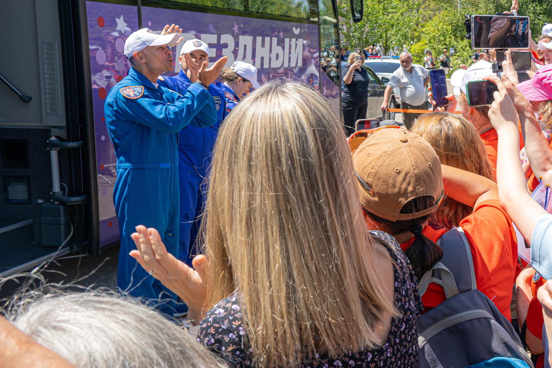 NASA astronaut candidate Anna Menon, foreground, watches as Expedition 75 crewmembers NASA astronaut Anil Menon and Roscosmos cosmonauts Pyotr Dubrov and Anna Kikina depart the Cosmonaut Hotel to suit up for launch, Tuesday, July 14, 2026, in Baikonur, Kazakhstan. The launch will send the trio to the International Space Station aboard the Soyuz MS-29 spacecraft. Photo Credit: (NASA/John Kraus)