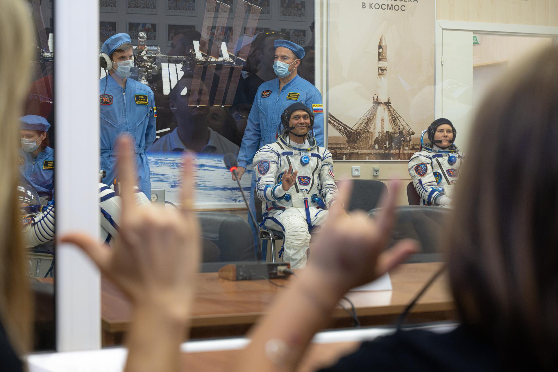 Expedition 75 crewmember NASA astronaut Anil Menon shares a moment with his wife, NASA astronaut candidate Anna Menon, and children before a pressure check of his Russian Sokul suit before launch, Tuesday, July 14, 2026, at the Baikonur Cosmodrome in Kazakhstan. The launch will send NASA astronaut Anil Menon and Roscosmos cosmonauts Pyotr Dubrov and Anna Kikina to the International Space Station aboard the Soyuz MS-29 spacecraft. Photo Credit: (NASA/John Kraus)