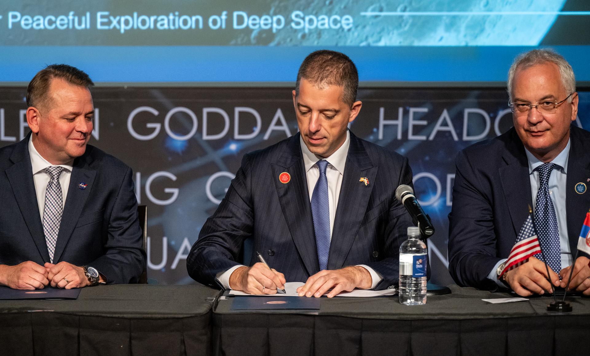 Minister of Foreign Affairs for Serbia Marko Đurić, center, joined by NASA Deputy Administrator Matt Anderson, left, and Ambassador of Serbia to the Unites States Dragan Šutanovac, right, signs the Artemis Accords Thursday, July 16, 2026, at the Mary W. Jackson NASA Headquarters building in Washington. Serbia is the 69th country to sign the Artemis Accords, which establish a practical set of principles to guide space exploration cooperation among nations participating in NASA’s Artemis program. Photo Credit: (NASA/Keegan Barber)