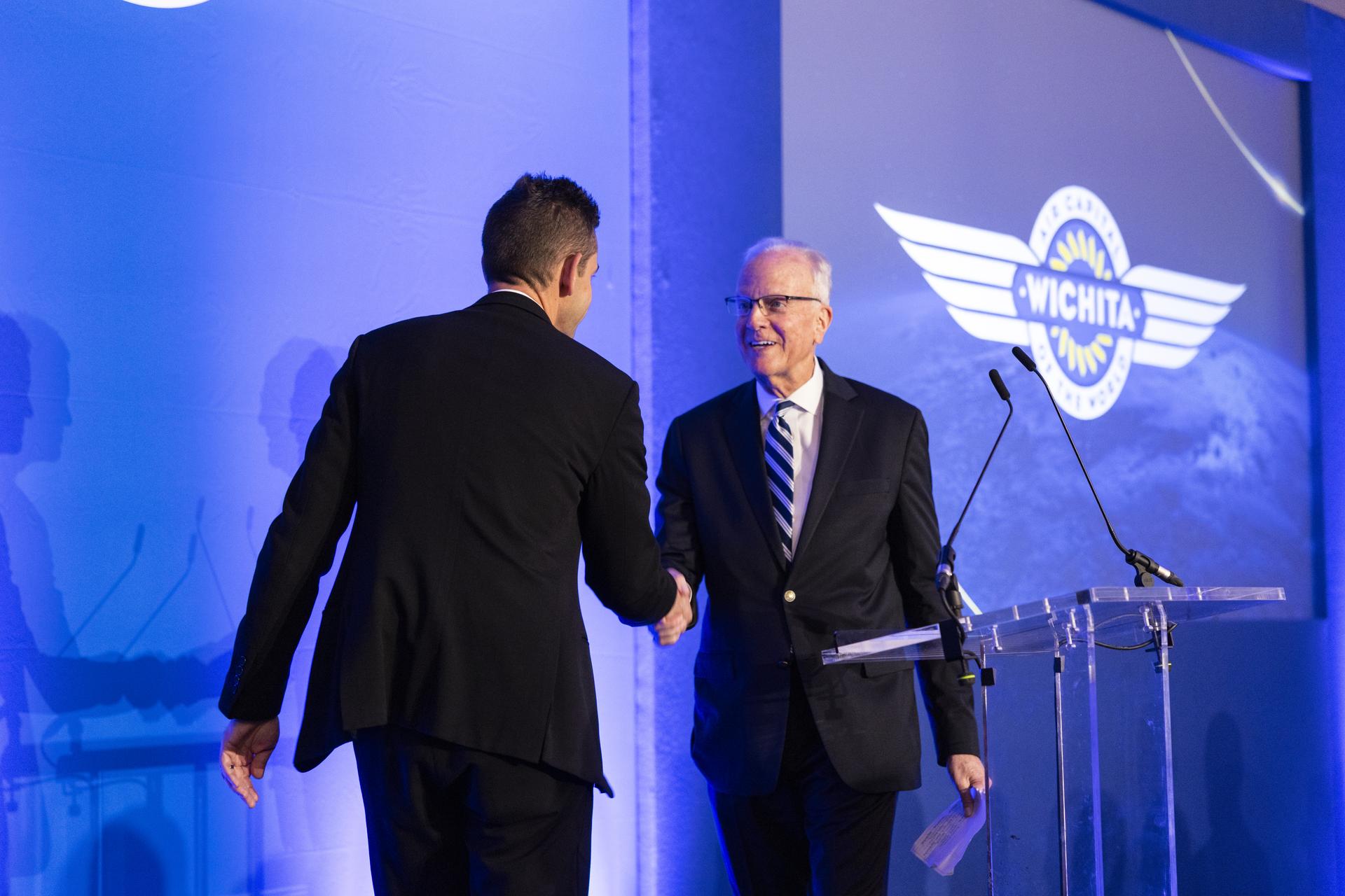 Jared Isaacman speaks at Air Capital of the World Celebration, main kick-off event for Farnborough International Airshow in the United Kingdom, pictured with Senator Jerry Moran (R-Kan).