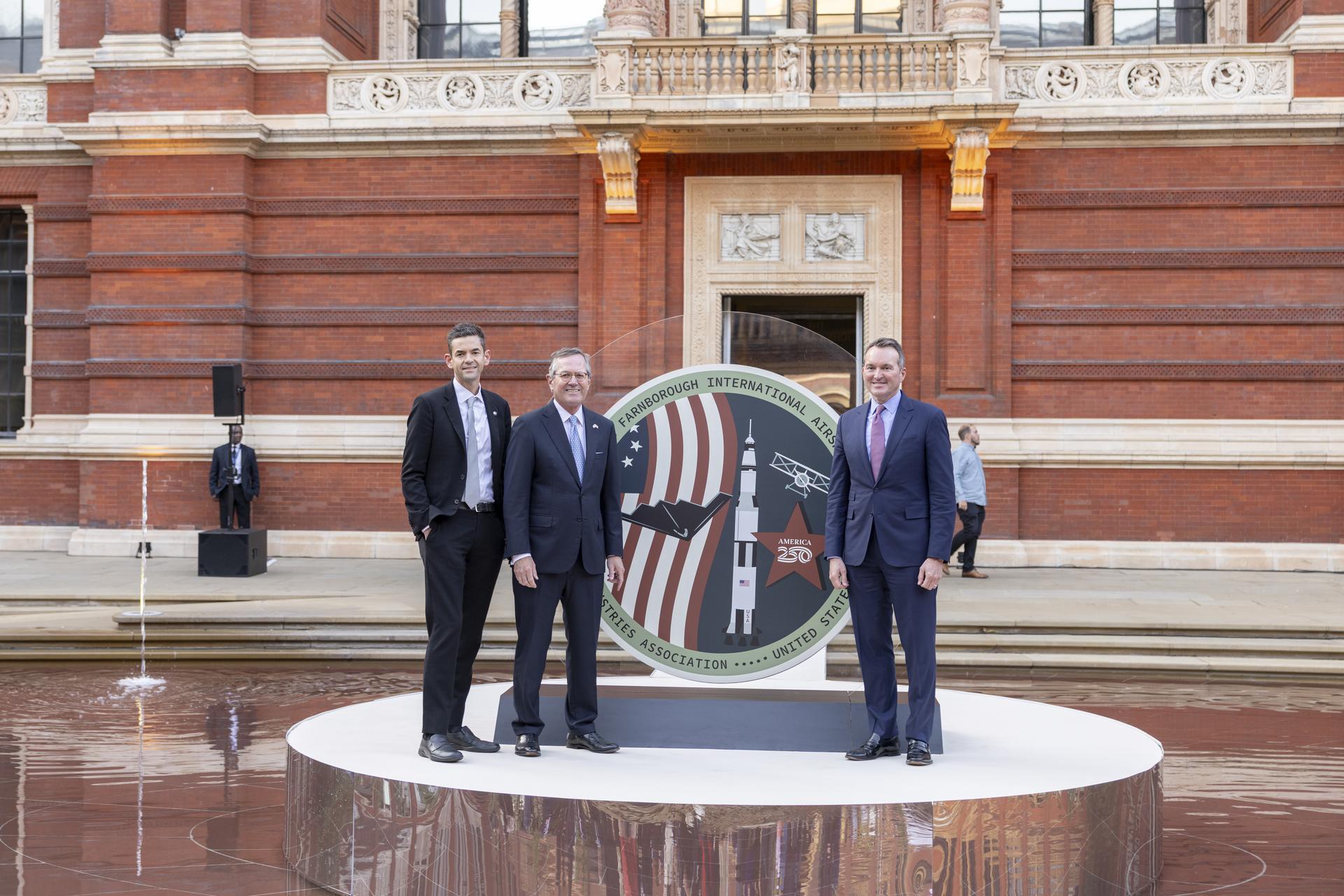 Jared Isaacman speaks at The Aerospace Industries Association Reception at the Victoria and Albert Museum in the United Kingdom. He is photographed with The Honorable Warren Stephens, United States Ambassador to the United Kingdom and AIA President and CEO Eric Fanning.
