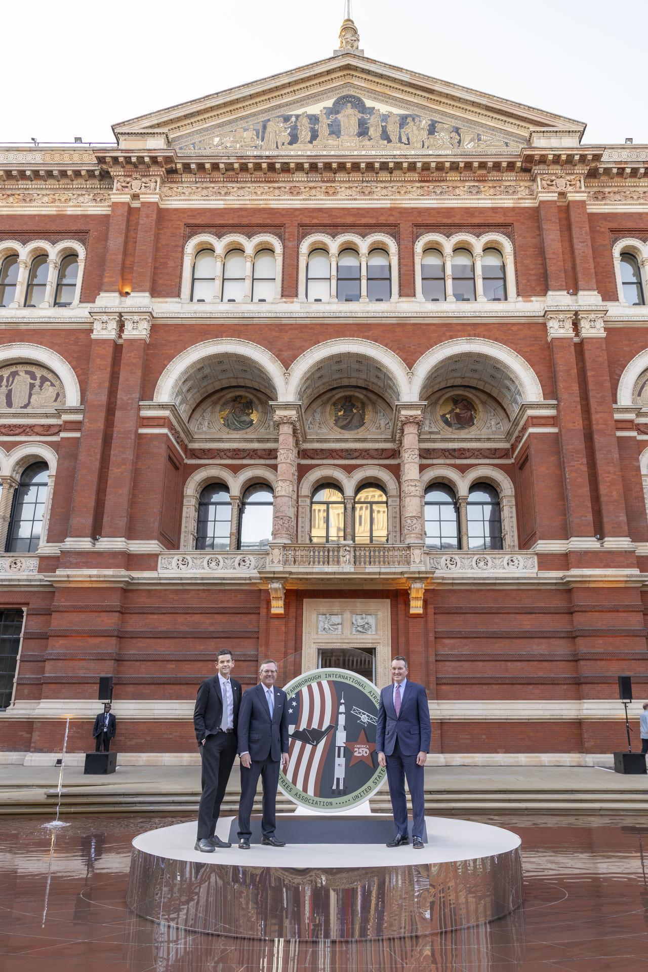 Jared Isaacman speaks at The Aerospace Industries Association Reception at the Victoria and Albert Museum in the United Kingdom. He is photographed with The Honorable Warren Stephens, United States Ambassador to the United Kingdom and AIA President and CEO Eric Fanning.