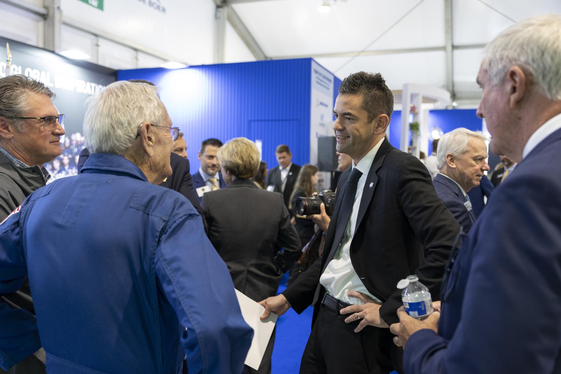 Jared Isaacman introduces Charlie Duke at the U.S. Pavillion at the Farnborough International Airshow in Farnborough, UK.