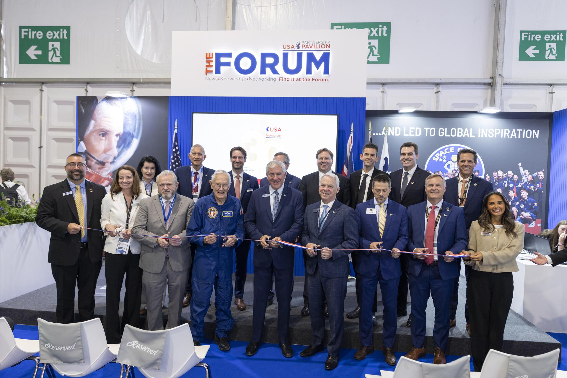 Jared Isaacman and Charlie Duke participate in the ribbon cutting for the U.S. Pavillion at Farnborough International Airshow in Farnborough, UK.