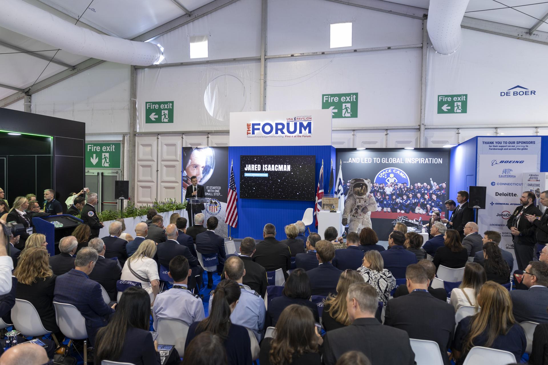 Jared Isaacman introduces Charlie Duke at the U.S. Pavillion at the Farnborough International Airshow in Farnborough, UK.