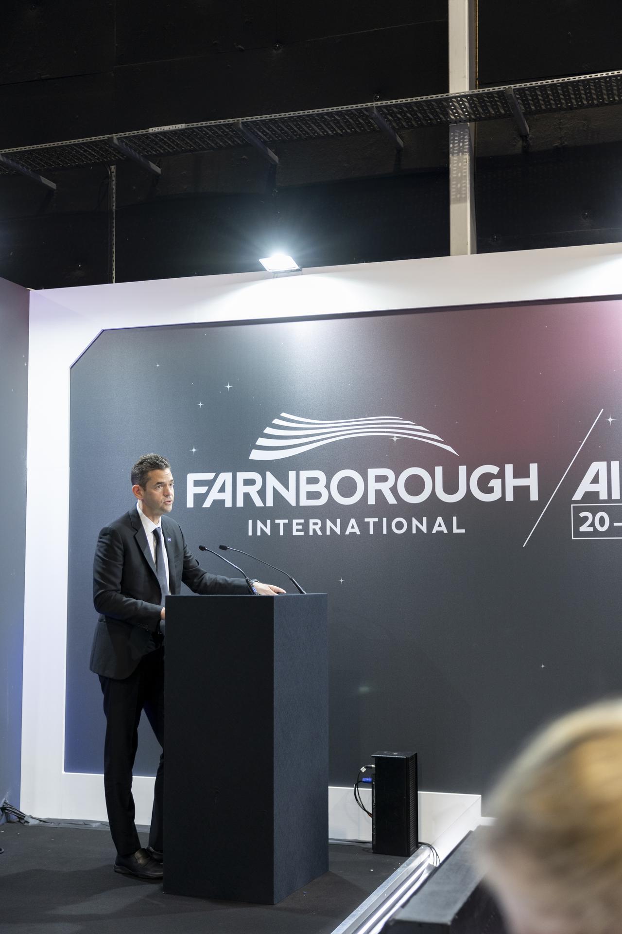 Jared Isaacman speaks at a booth at the Farnborough International Airshow in Farnborough, UK.