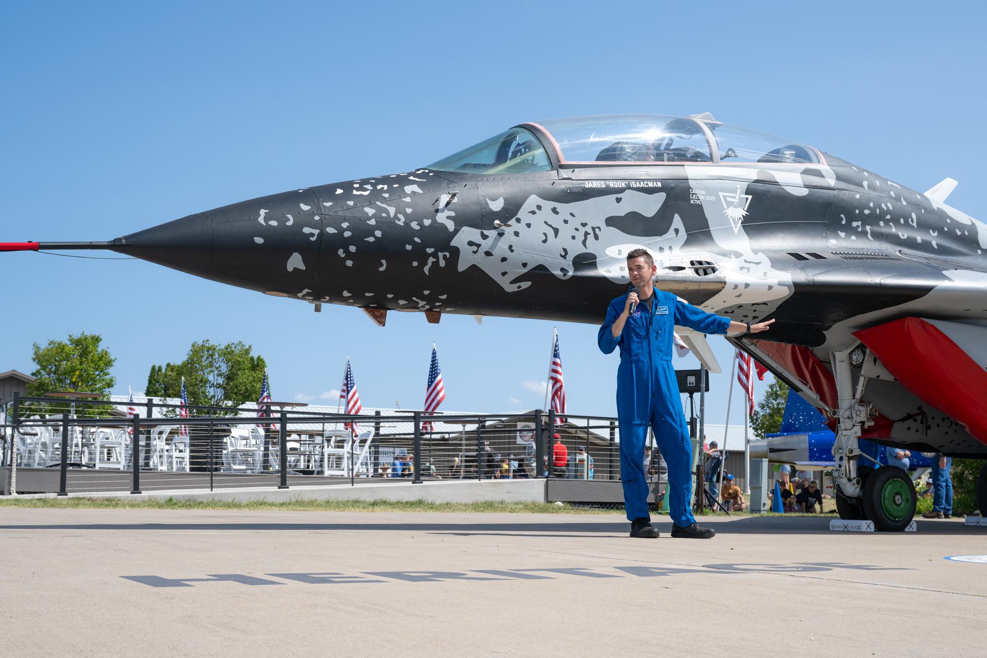 NASA Administrator Jared Isaacman speaks to the capabilities of his personal MiG-29 aircraft during a “Warbirds in Review” presentation, Thursday, July 23, 2026, at EAA AirVenture Oshkosh at Wittman Regional Airport in Oshkosh, Wis. Isaacman discussed NASA’s efforts in air and space, his aviation experience, and more. Photo Credit: (NASA/John Kraus)