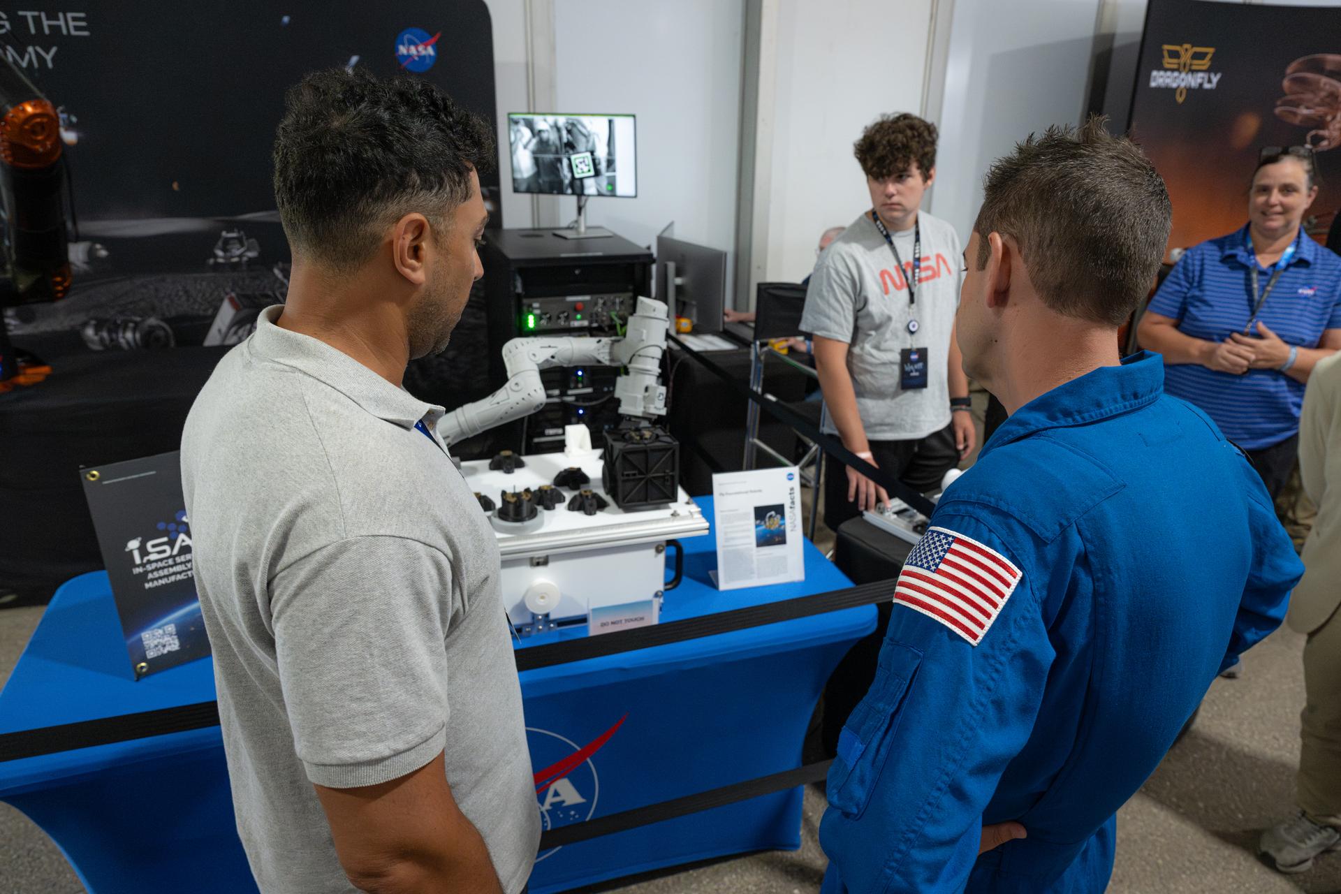 NASA Administrator Jared Isaacman speaks with a member of the NASA workforce, Friday, July 24, 2026, at NASA's exhibit at EAA AirVenture Oshkosh at Wittman Regional Airport in Oshkosh, Wis. Photo Credit: (NASA/John Kraus)