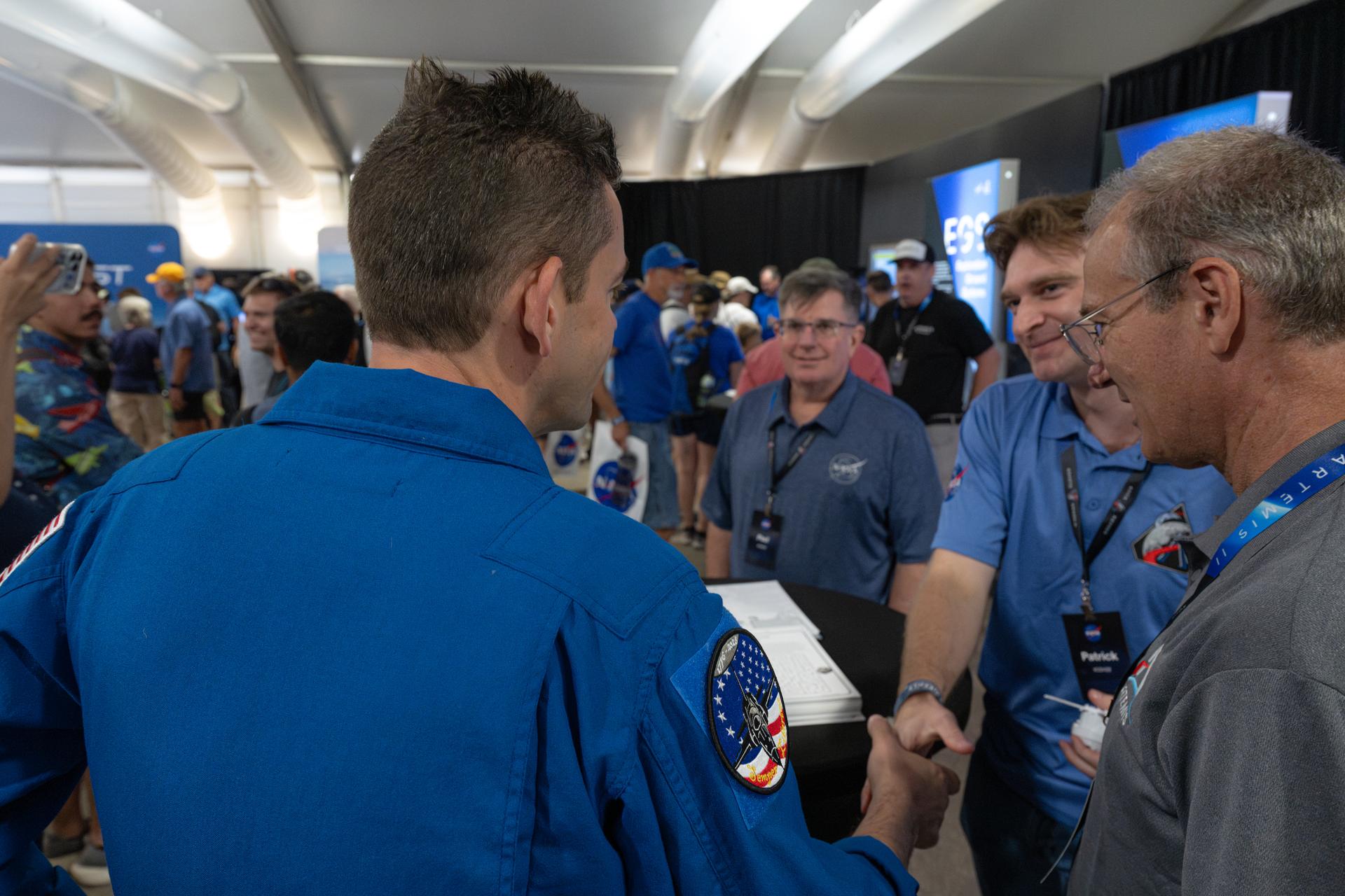 NASA Administrator Jared Isaacman greets a member of the NASA workforce, Friday, July 24, 2026, at NASA's exhibit at EAA AirVenture Oshkosh at Wittman Regional Airport in Oshkosh, Wis. Photo Credit: (NASA/John Kraus)