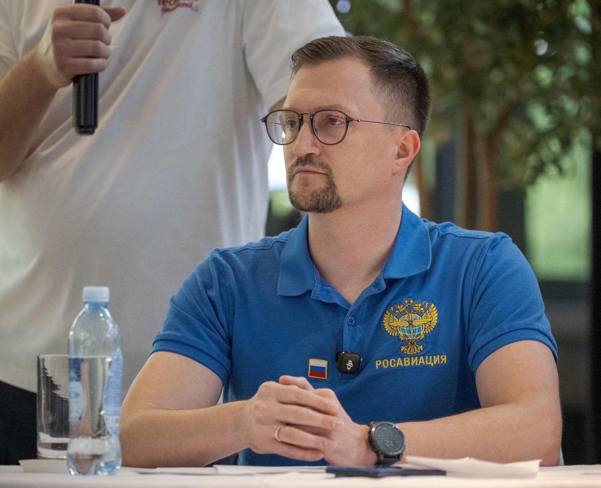 Head of the Search-and-Rescue Department of Rosaviatsiya (Russian Federal Agency for Air Transport) Andrey Aleksandrovich, is seen as NASA, Roscosmos, and Russian Search and Recovery Forces meet at the Cosmonaut Hotel in Karaganda, Kazakhstan, Saturday, July 25, 2026, to discuss the readiness for the landing of Expedition 74 NASA astronaut Chris Williams, and Roscosmos cosmonauts Sergey Kud-Sverchkov, and Sergei Mikaev. Photo Credit: (NASA/Bill Ingalls)