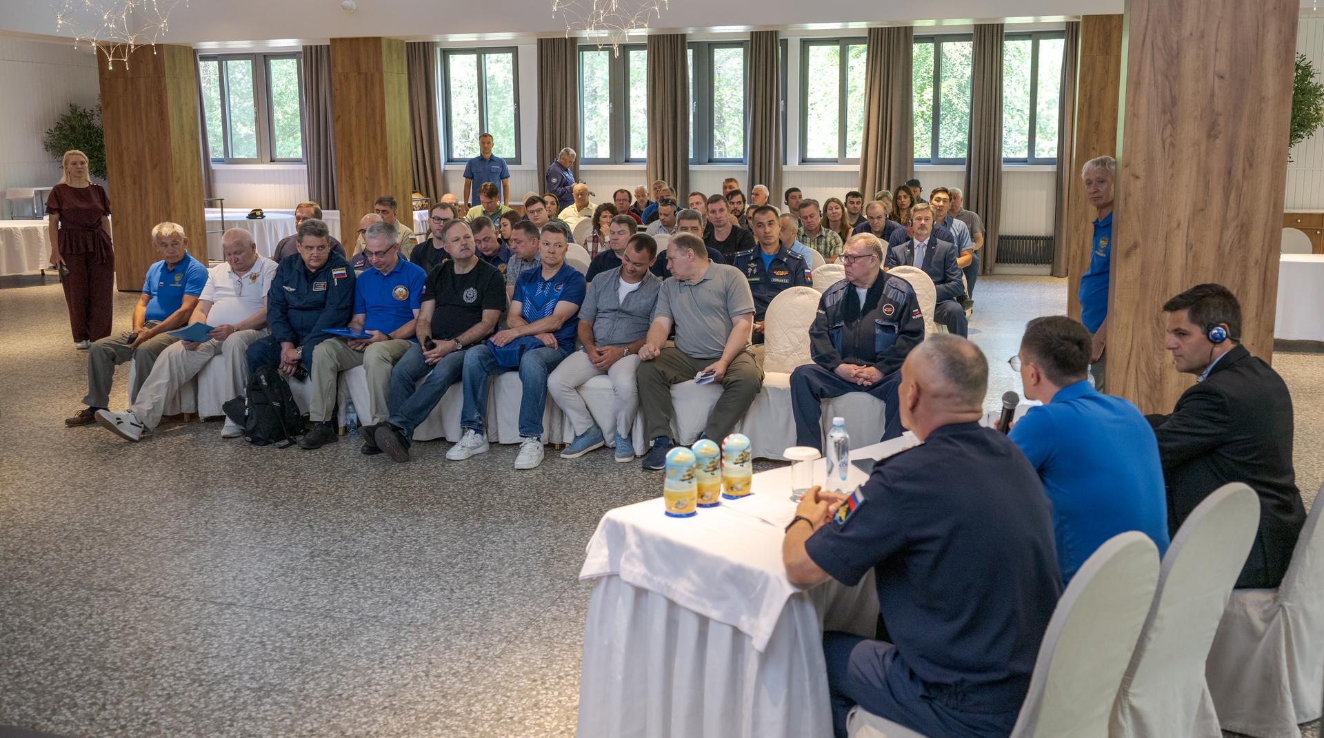 NASA, Roscosmos, and Russian Search and Recovery Forces meet at the Cosmonaut Hotel in Karaganda, Kazakhstan, Saturday, July 25, 2026, to discuss the readiness for the landing of Expedition 74 NASA astronaut Chris Williams, and Roscosmos cosmonauts Sergey Kud-Sverchkov, and Sergei Mikaev. Photo Credit: (NASA/Bill Ingalls)