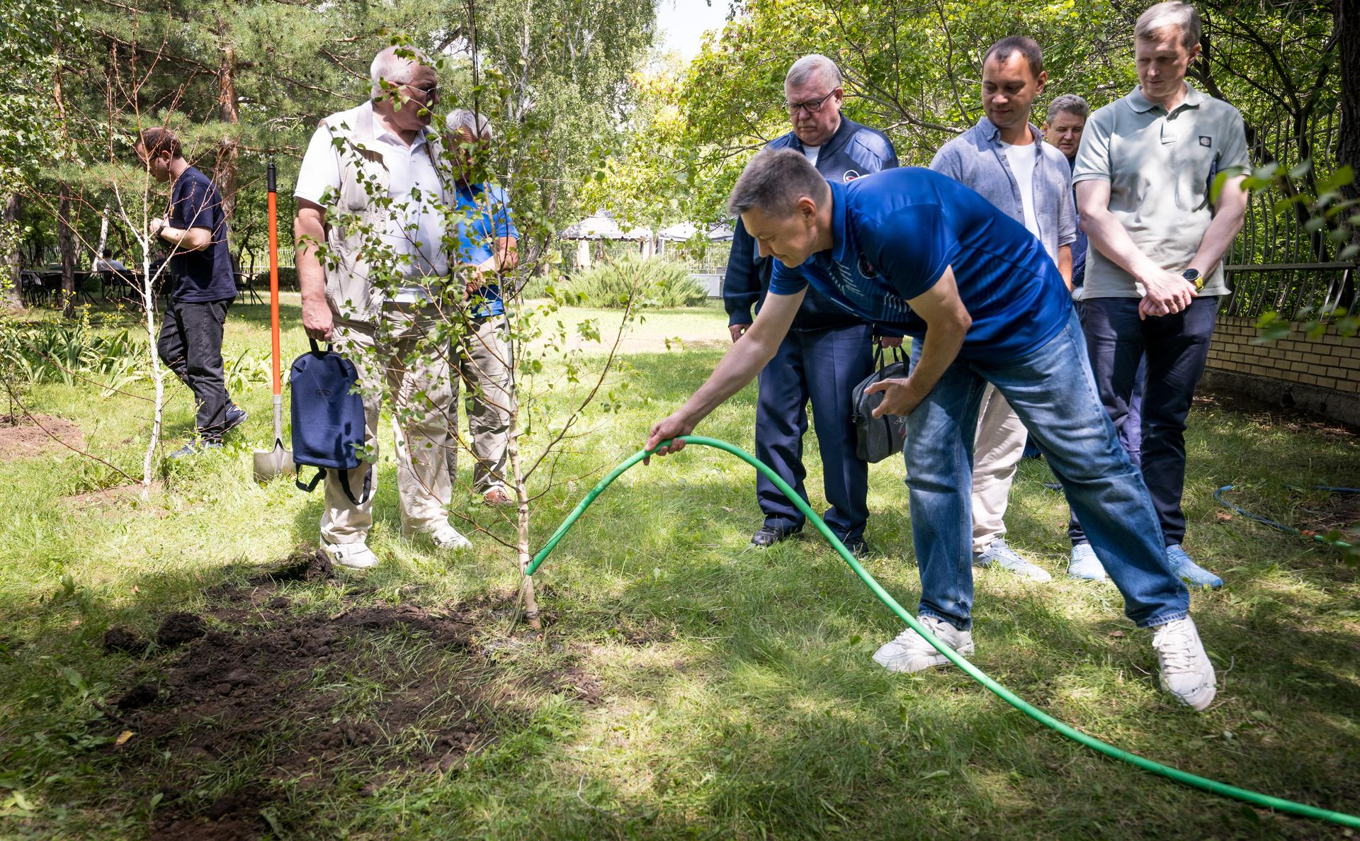 Head of Gargarin Cosmonaut Training Center Oleg Kononenko plants a tree during a traditional ceremony at the Cosmonaut Hotel in Karaganda, Kazakhstan, Saturday, July 25. Kononenko is in Karaganda to help support the Expedition 74 crew Soyuz landing from the International Space Station. Photo Credit: (NASA/Bill Ingalls)