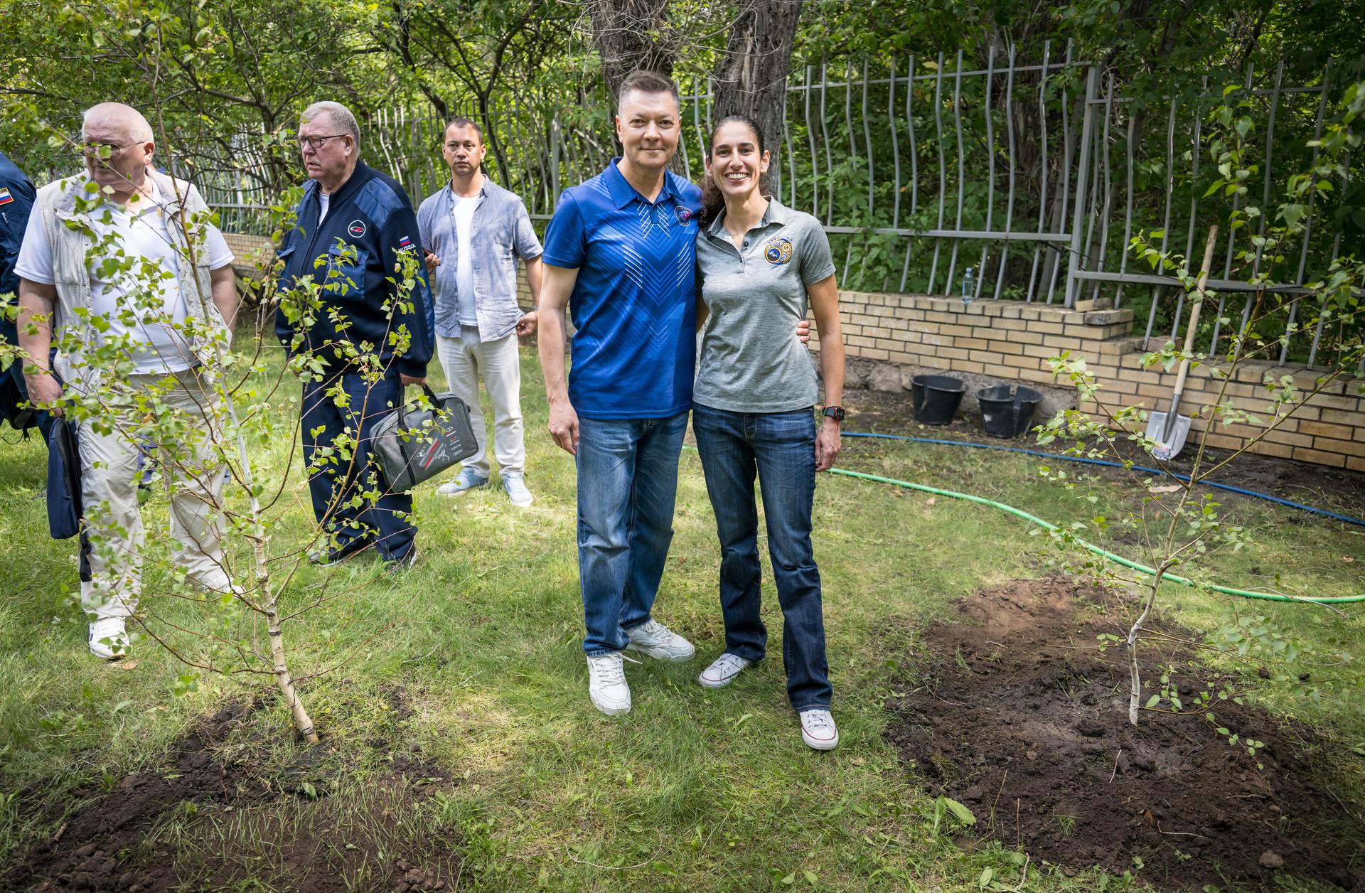 Head of Gargarin Cosmonaut Training Center Oleg Kononenko, left, and NASA Astronaut Office representative Jasmin Moghbeli pose for a photograph after both having planted trees during a traditional ceremony at the Cosmonaut Hotel in Karaganda, Kazakhstan, Saturday, July 25. Kononenko and Moghbeli are in Karaganda to help support the Expedition 74 crew Soyuz landing from the International Space Station. Photo Credit: (NASA/Bill Ingalls)