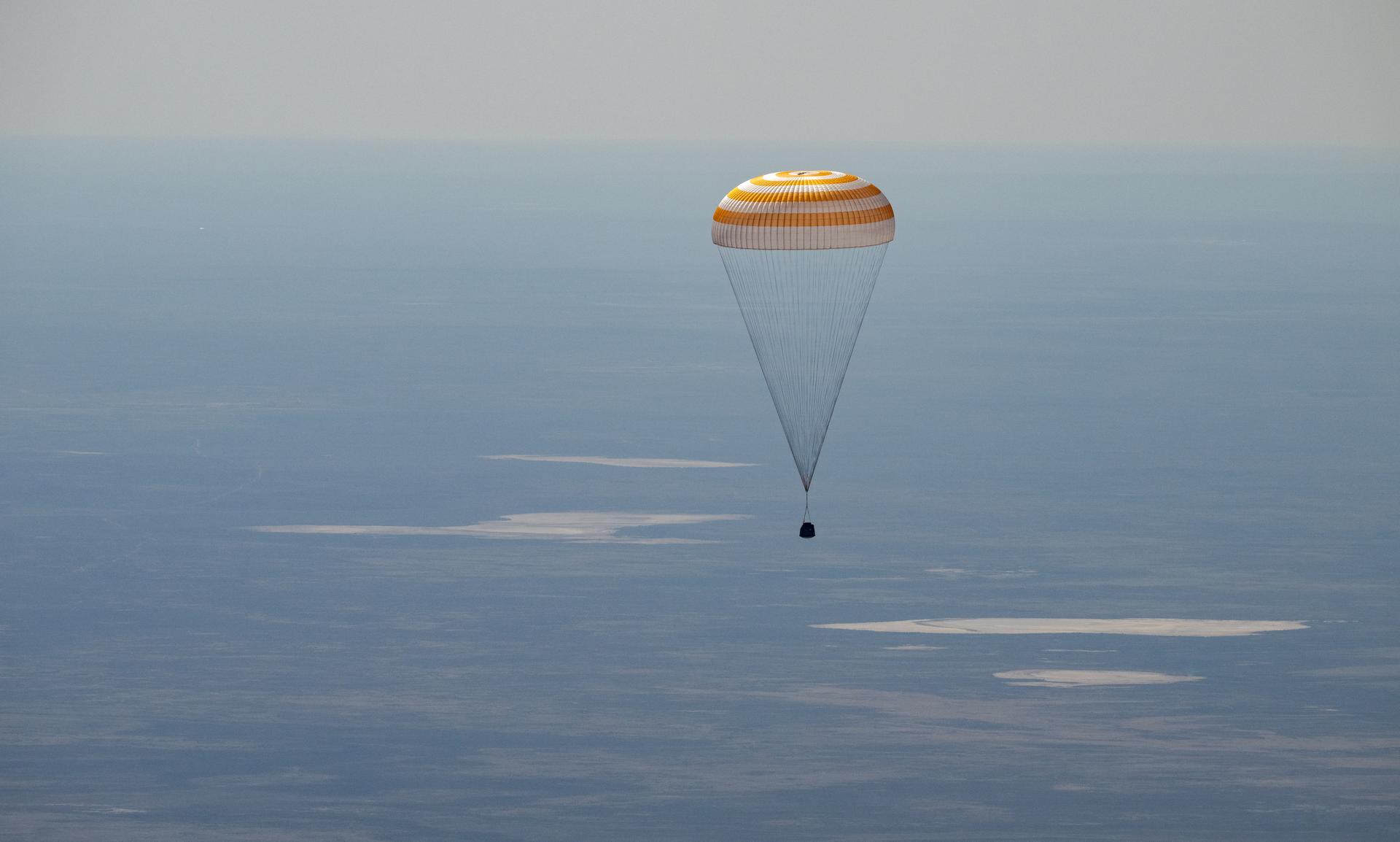 The Soyuz MS-28 spacecraft is seen as it lands in a remote area near the town of Zhezkazgan, Kazakhstan with Expedition 74 NASA astronaut Chris Williams, and Roscosmos cosmonauts Sergey Kud-Sverchkov, and Sergei Mikaev aboard, Sunday, July 26, 2026. The trio are returning to Earth after logging 241 days in space as members of Expeditions 73 and 74 aboard the International Space Station. Photo Credit: (NASA/Bill Ingalls)