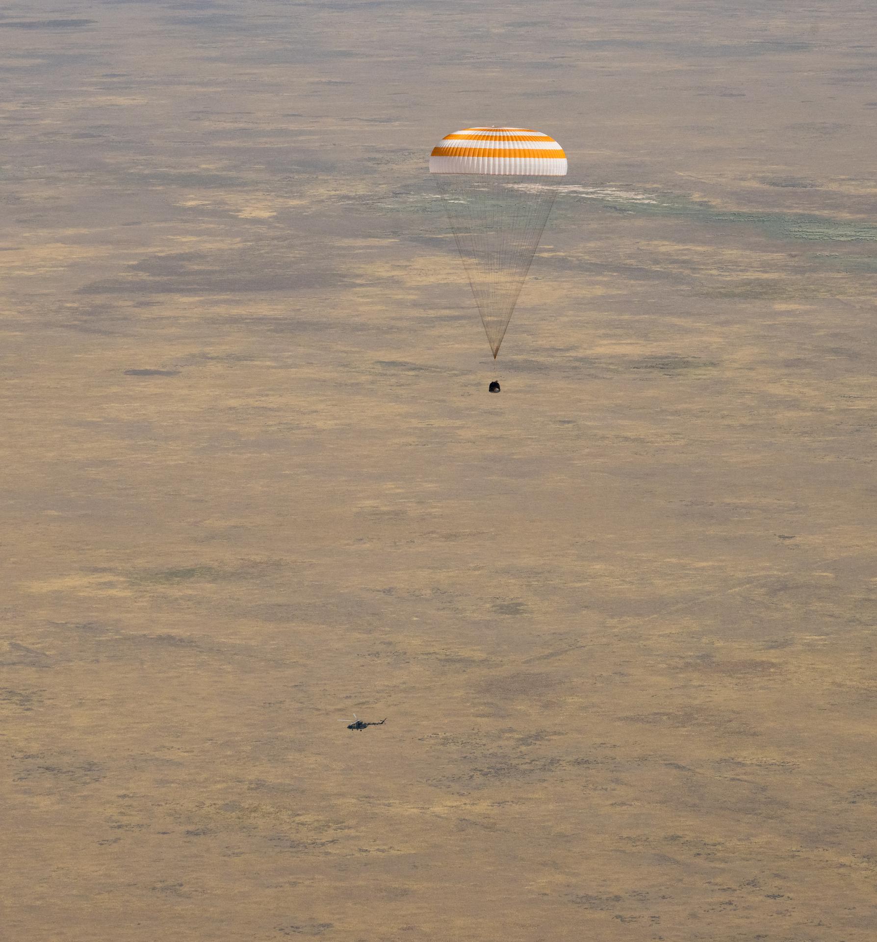 The Soyuz MS-28 spacecraft is seen as it lands in a remote area near the town of Zhezkazgan, Kazakhstan with Expedition 74 NASA astronaut Chris Williams, and Roscosmos cosmonauts Sergey Kud-Sverchkov, and Sergei Mikaev aboard, Sunday, July 26, 2026. The trio are returning to Earth after logging 241 days in space as members of Expeditions 73 and 74 aboard the International Space Station. Photo Credit: (NASA/Bill Ingalls)
