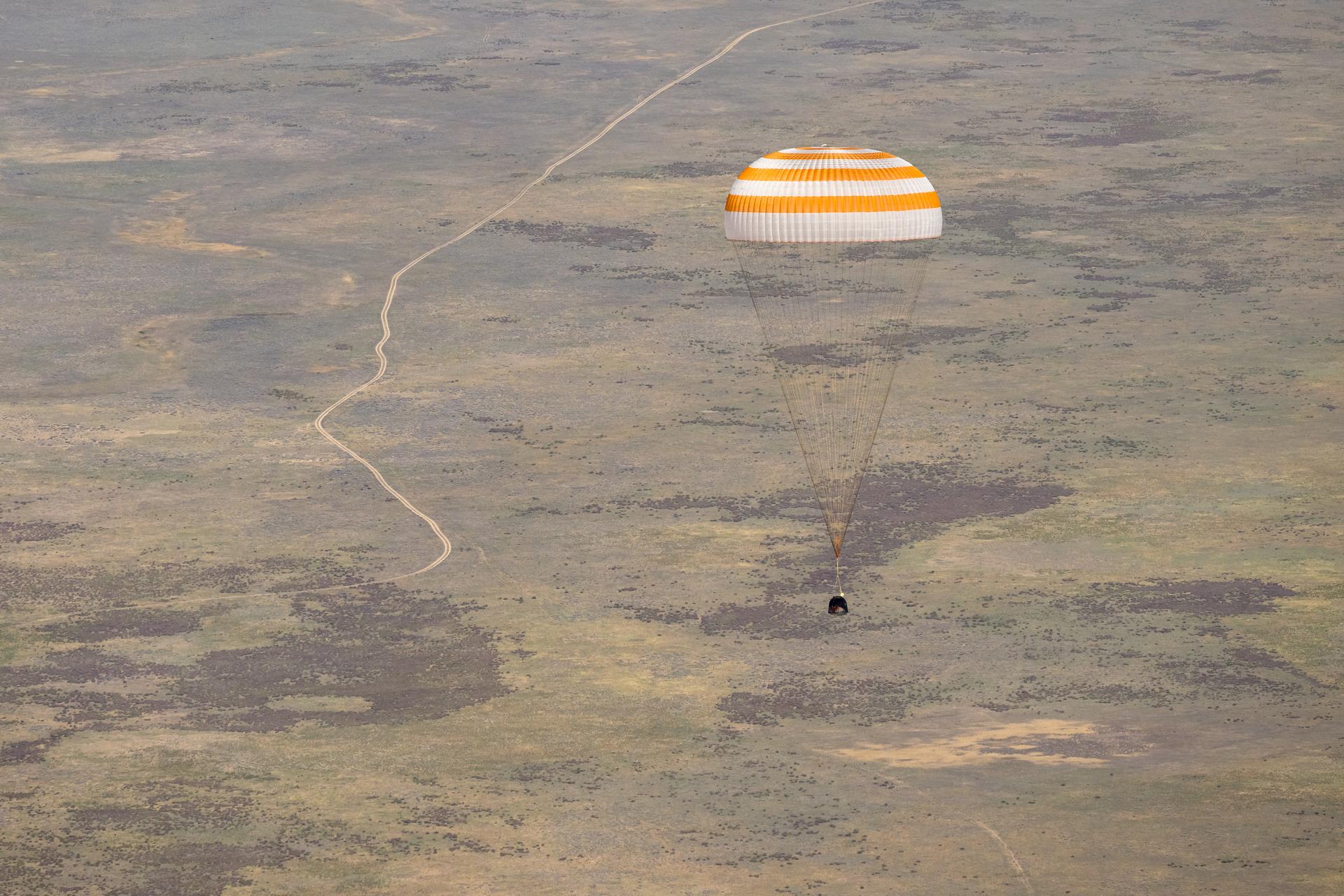 The Soyuz MS-28 spacecraft is seen as it lands in a remote area near the town of Zhezkazgan, Kazakhstan with Expedition 74 NASA astronaut Chris Williams, and Roscosmos cosmonauts Sergey Kud-Sverchkov, and Sergei Mikaev aboard, Sunday, July 26, 2026. The trio are returning to Earth after logging 241 days in space as members of Expeditions 73 and 74 aboard the International Space Station. Photo Credit: (NASA/Bill Ingalls)