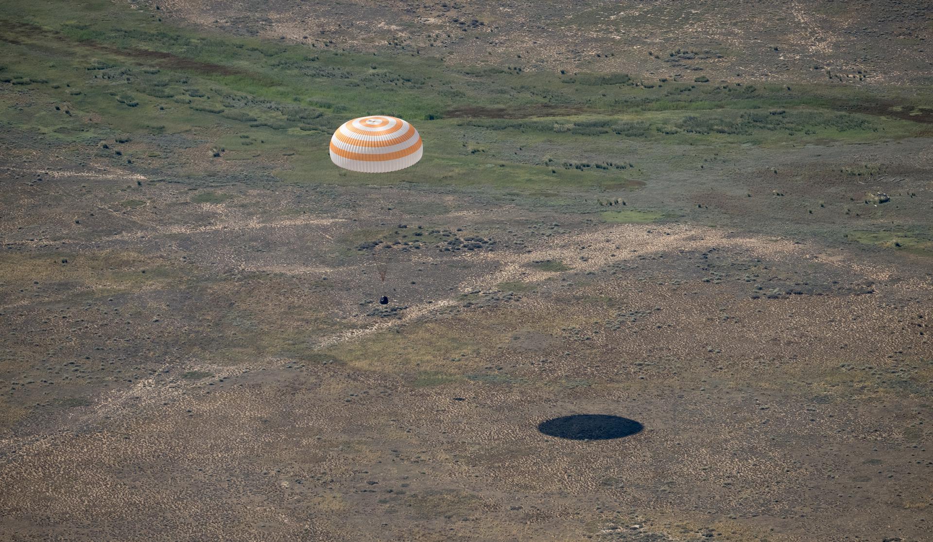 The Soyuz MS-28 spacecraft is seen as it lands in a remote area near the town of Zhezkazgan, Kazakhstan with Expedition 74 NASA astronaut Chris Williams, and Roscosmos cosmonauts Sergey Kud-Sverchkov, and Sergei Mikaev aboard, Sunday, July 26, 2026. The trio are returning to Earth after logging 241 days in space as members of Expeditions 73 and 74 aboard the International Space Station. Photo Credit: (NASA/Bill Ingalls)