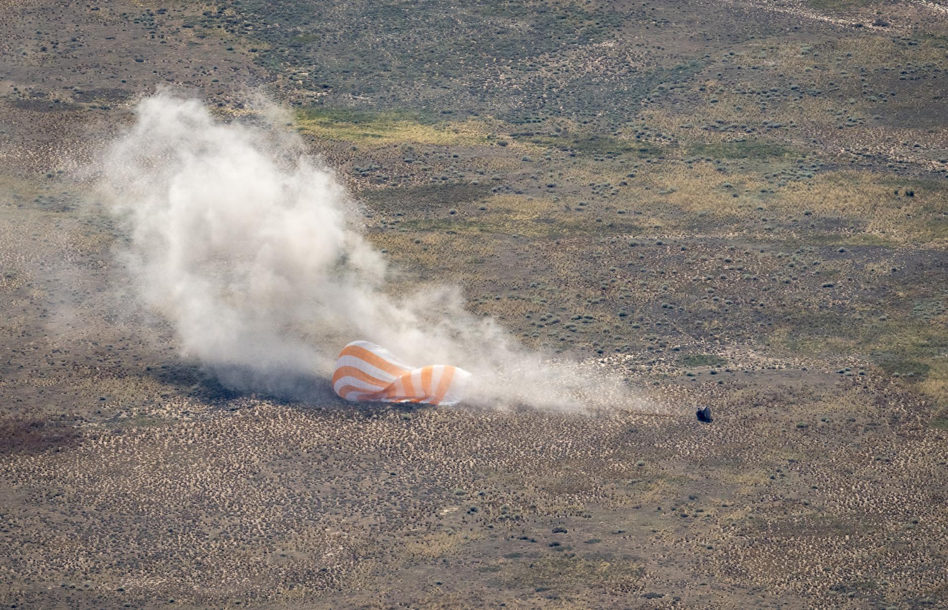 The Soyuz MS-28 spacecraft is seen as it lands in a remote area near the town of Zhezkazgan, Kazakhstan with Expedition 74 NASA astronaut Chris Williams, and Roscosmos cosmonauts Sergey Kud-Sverchkov, and Sergei Mikaev aboard, Sunday, July 26, 2026. The trio are returning to Earth after logging 241 days in space as members of Expeditions 73 and 74 aboard the International Space Station. Photo Credit: (NASA/Bill Ingalls)