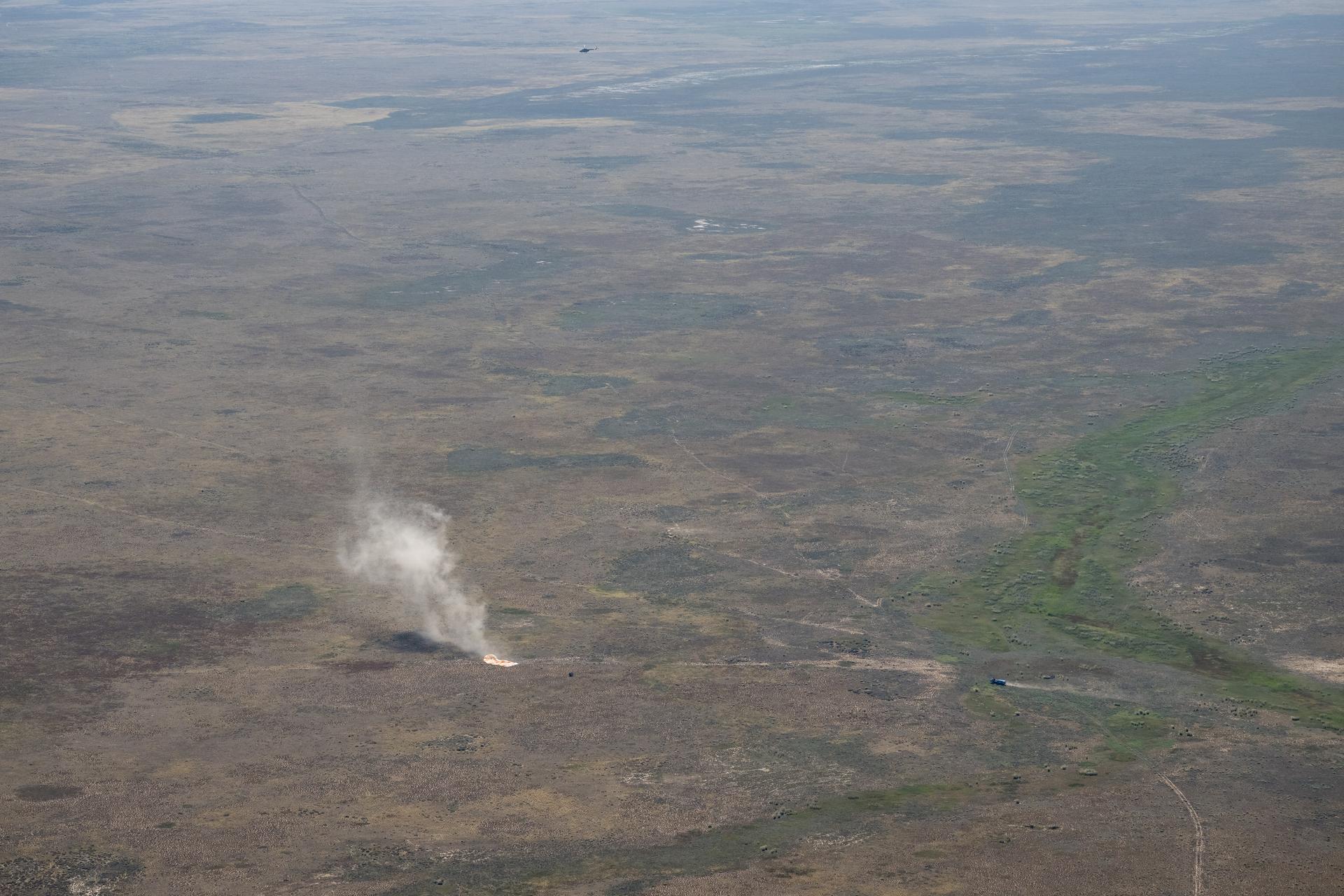 The Soyuz MS-28 spacecraft is seen as it lands in a remote area near the town of Zhezkazgan, Kazakhstan with Expedition 74 NASA astronaut Chris Williams, and Roscosmos cosmonauts Sergey Kud-Sverchkov, and Sergei Mikaev aboard, Sunday, July 26, 2026. The trio are returning to Earth after logging 241 days in space as members of Expeditions 73 and 74 aboard the International Space Station. Photo Credit: (NASA/Bill Ingalls)