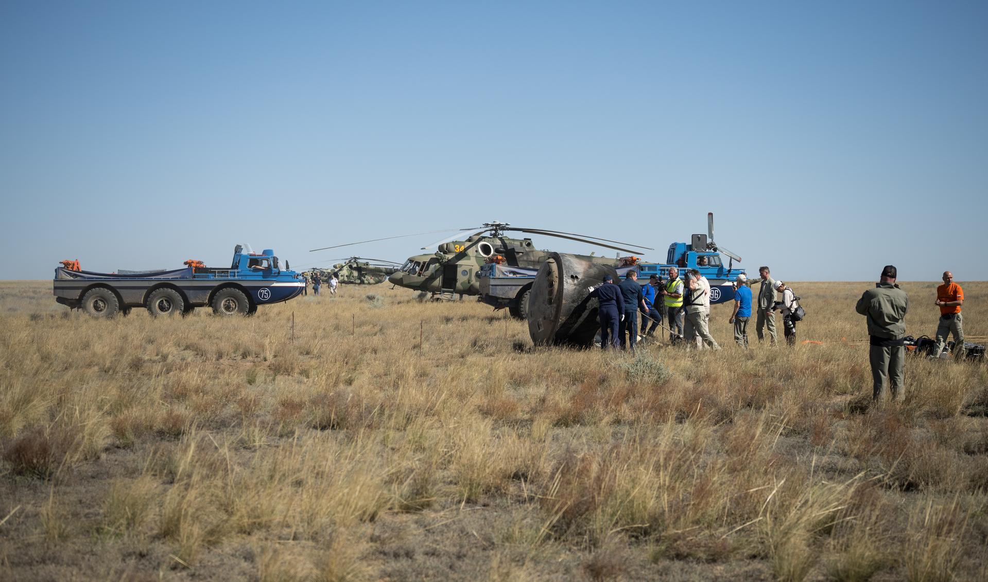 Russian Search and Rescue teams arrive at the Soyuz MS-28 spacecraft shortly after it landed in a remote area near the town of Zhezkazgan, Kazakhstan with  Expedition 74 NASA astronaut Chris Williams, and Roscosmos cosmonauts Sergey Kud-Sverchkov, and Sergei Mikaev aboard, Sunday, July 26, 2026. The trio returned to Earth after logging 241 days in space as a members of Expeditions 73 and 74 aboard the International Space Station. Photo Credit: (NASA/Bill Ingalls)