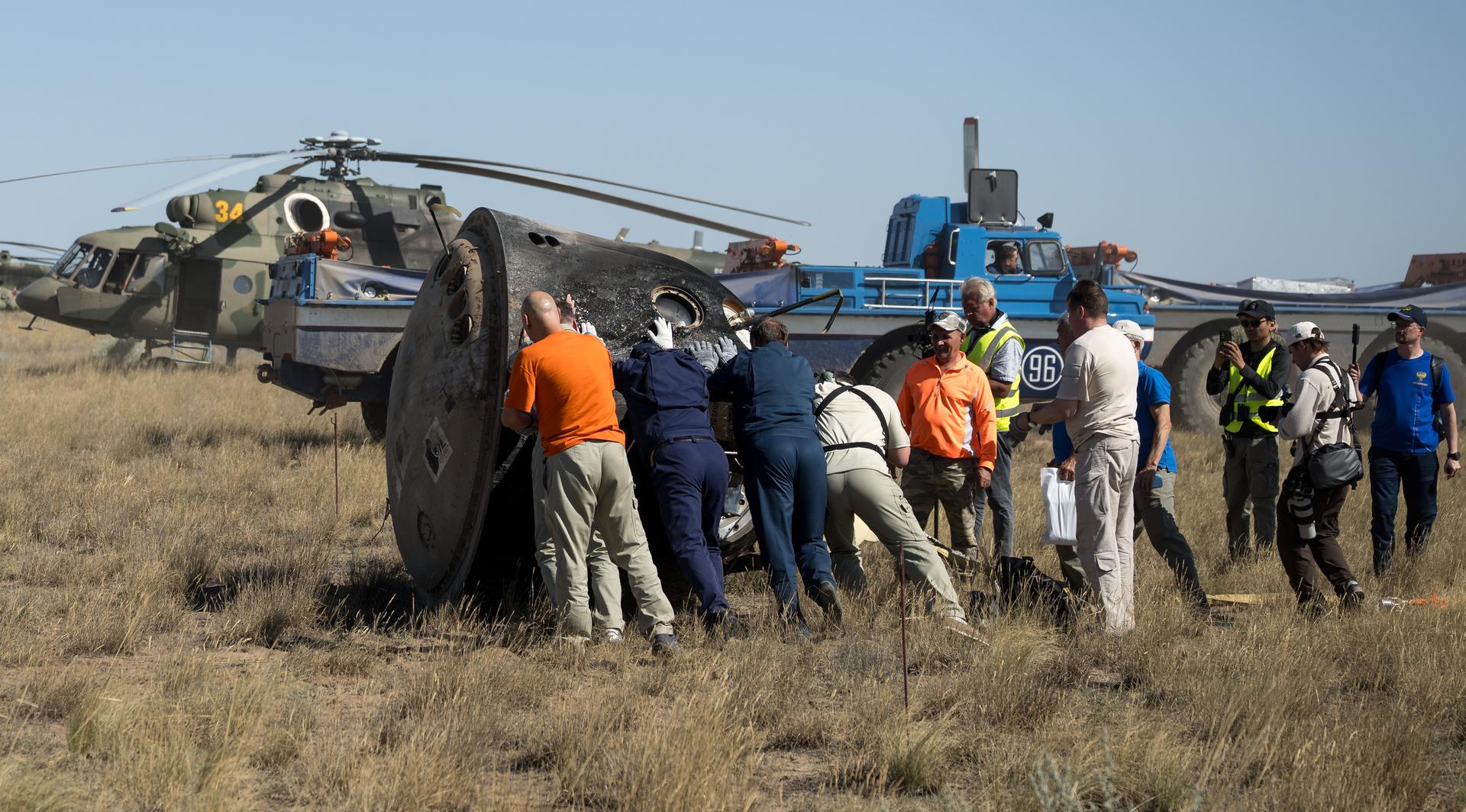Russian Search and Rescue teams arrive at the Soyuz MS-28 spacecraft shortly after it landed in a remote area near the town of Zhezkazgan, Kazakhstan with  Expedition 74 NASA astronaut Chris Williams, and Roscosmos cosmonauts Sergey Kud-Sverchkov, and Sergei Mikaev aboard, Sunday, July 26, 2026. The trio returned to Earth after logging 241 days in space as a members of Expeditions 73 and 74 aboard the International Space Station. Photo Credit: (NASA/Bill Ingalls)