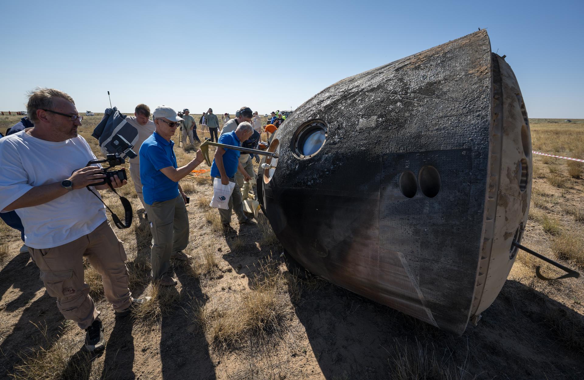 Russian Search and Rescue teams arrive at the Soyuz MS-28 spacecraft shortly after it landed in a remote area near the town of Zhezkazgan, Kazakhstan with  Expedition 74 NASA astronaut Chris Williams, and Roscosmos cosmonauts Sergey Kud-Sverchkov, and Sergei Mikaev aboard, Sunday, July 26, 2026. The trio returned to Earth after logging 241 days in space as a members of Expeditions 73 and 74 aboard the International Space Station. Photo Credit: (NASA/Bill Ingalls)