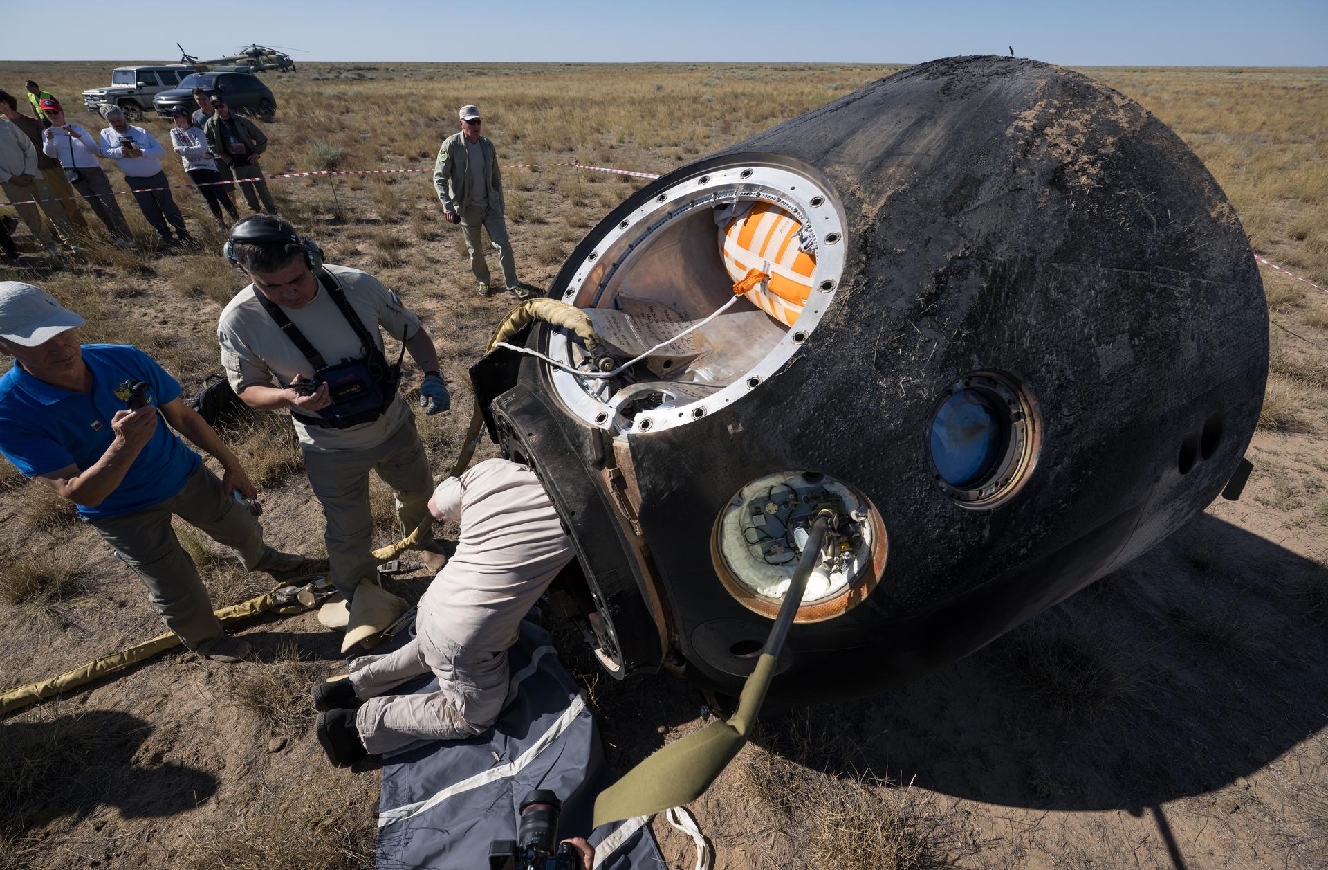 Russian Search and Rescue teams arrive at the Soyuz MS-28 spacecraft shortly after it landed in a remote area near the town of Zhezkazgan, Kazakhstan with  Expedition 74 NASA astronaut Chris Williams, and Roscosmos cosmonauts Sergey Kud-Sverchkov, and Sergei Mikaev aboard, Sunday, July 26, 2026. The trio returned to Earth after logging 241 days in space as a members of Expeditions 73 and 74 aboard the International Space Station. Photo Credit: (NASA/Bill Ingalls)