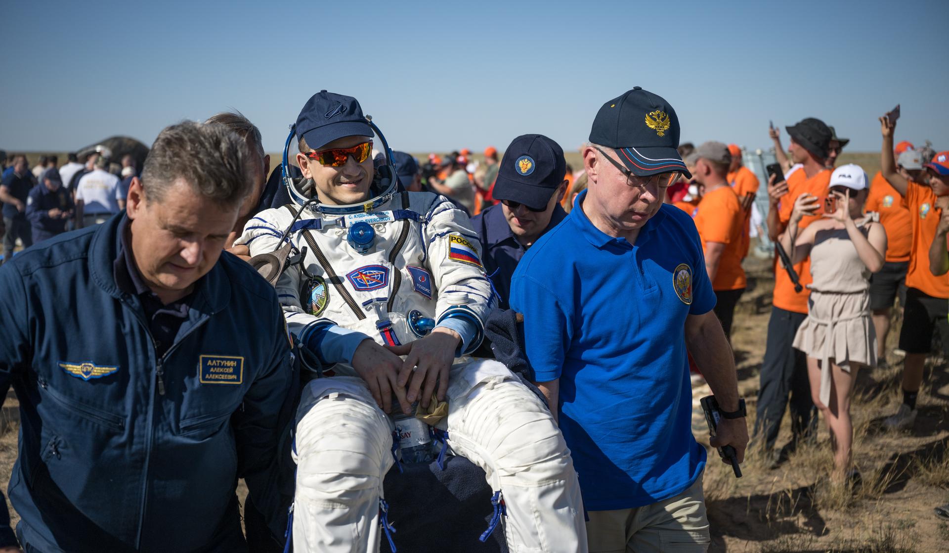 Roscosmos cosmonaut Sergey Kud-Sverchkov is carried to a medical tent shortly after he, Roscosmos cosmonaut Sergei Mikaev, and NASA astronaut Chris Williams landed in their Soyuz MS-28 spacecraft near the town of Zhezkazgan, Kazakhstan on Sunday, July 26, 2026. The trio returned to Earth after logging 241 days in space as a members of Expeditions 73 and 74 aboard the International Space Station. Photo Credit: (NASA/Bill Ingalls)