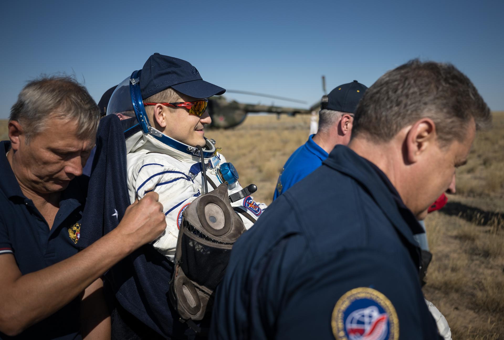 Roscosmos cosmonaut Sergey Kud-Sverchkov is carried to a medical tent shortly after he, Roscosmos cosmonaut Sergei Mikaev, and NASA astronaut Chris Williams landed in their Soyuz MS-28 spacecraft near the town of Zhezkazgan, Kazakhstan on Sunday, July 26, 2026. The trio returned to Earth after logging 241 days in space as a members of Expeditions 73 and 74 aboard the International Space Station. Photo Credit: (NASA/Bill Ingalls)